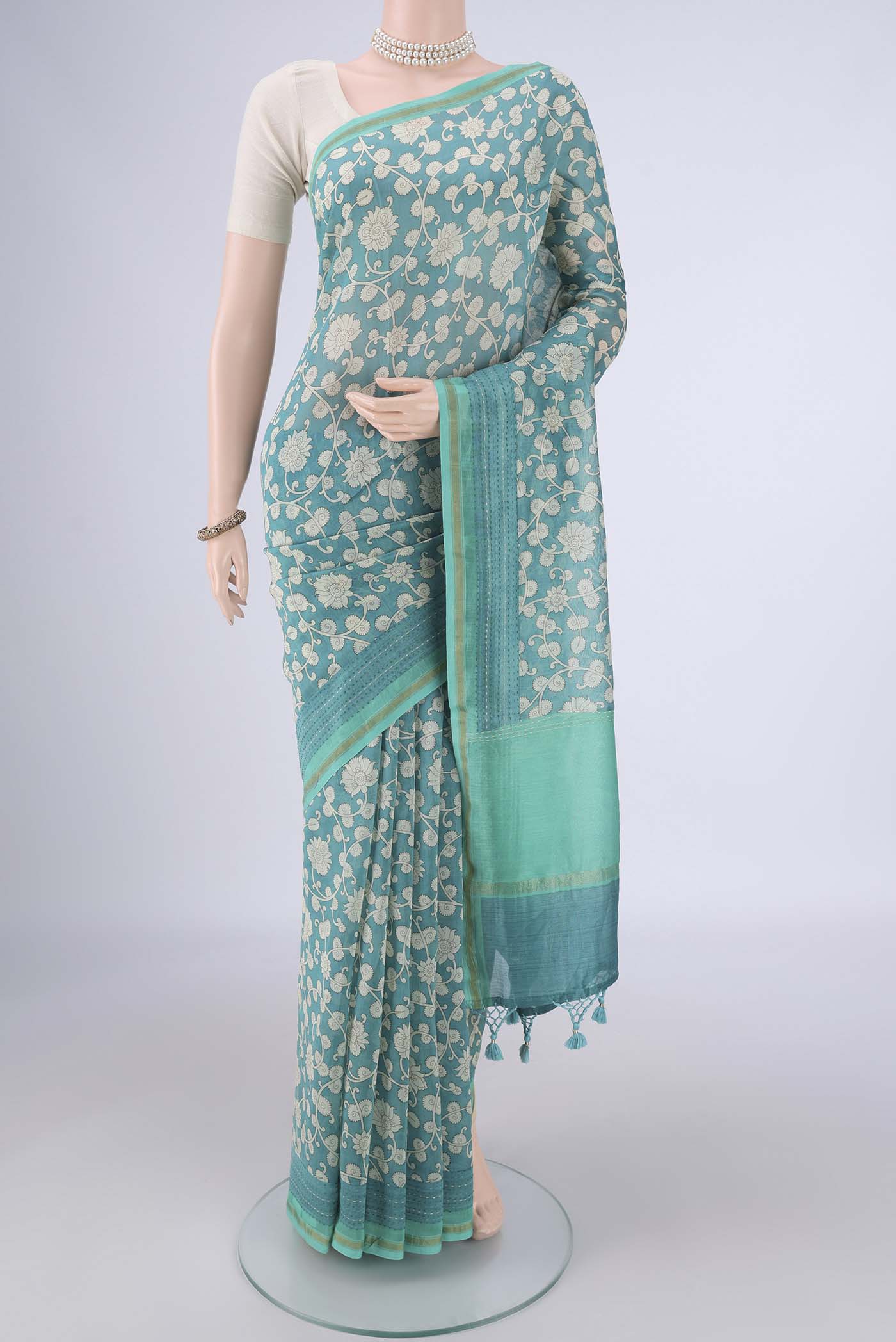 Blue Chanderi Silk Cotton Saree with Printed design on the body and Thread Border.  displayed on a mannequin