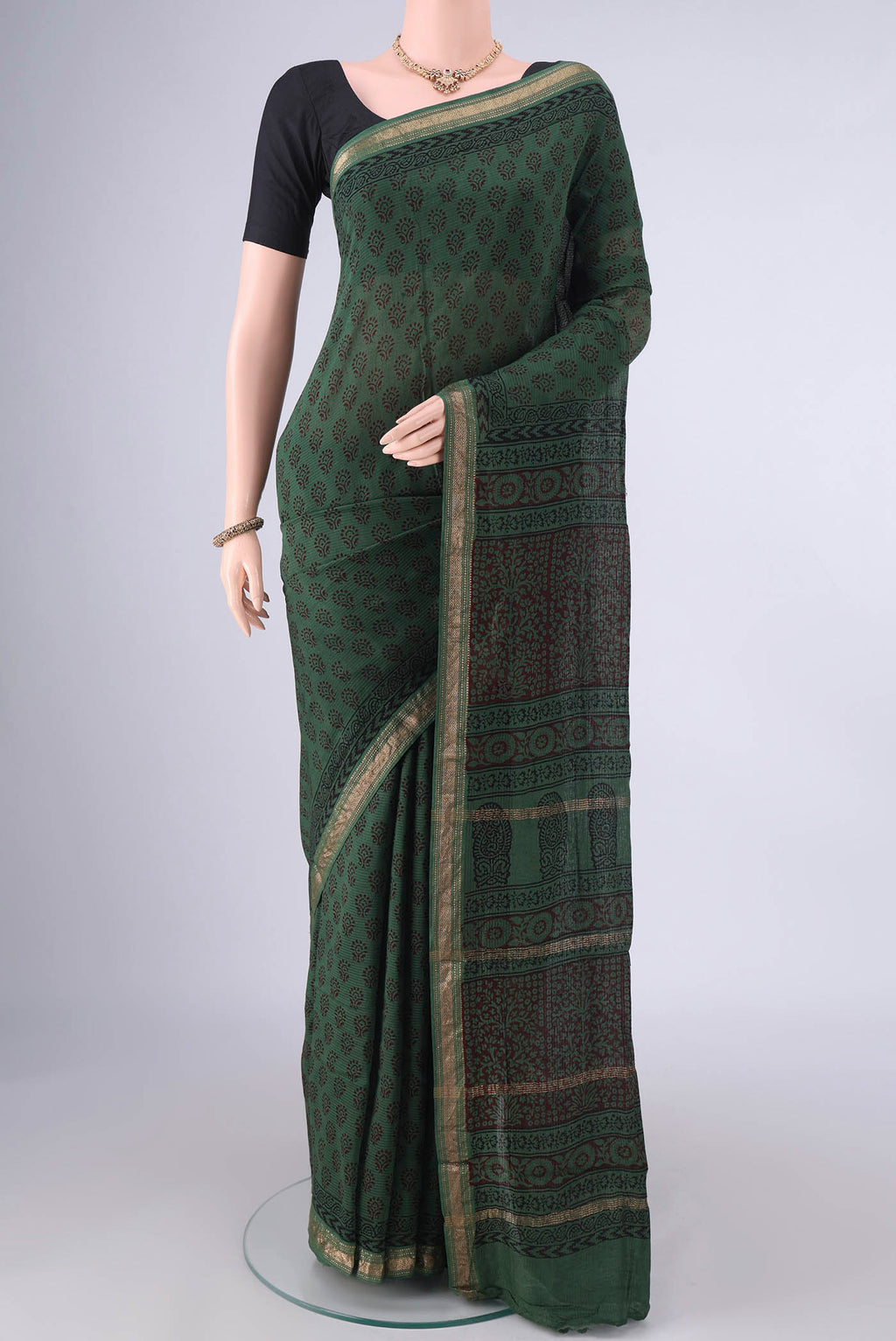 Olive Green Maheshwari Cotton Saree with Printed design on the body and Zari Border.  displayed on a mannequin