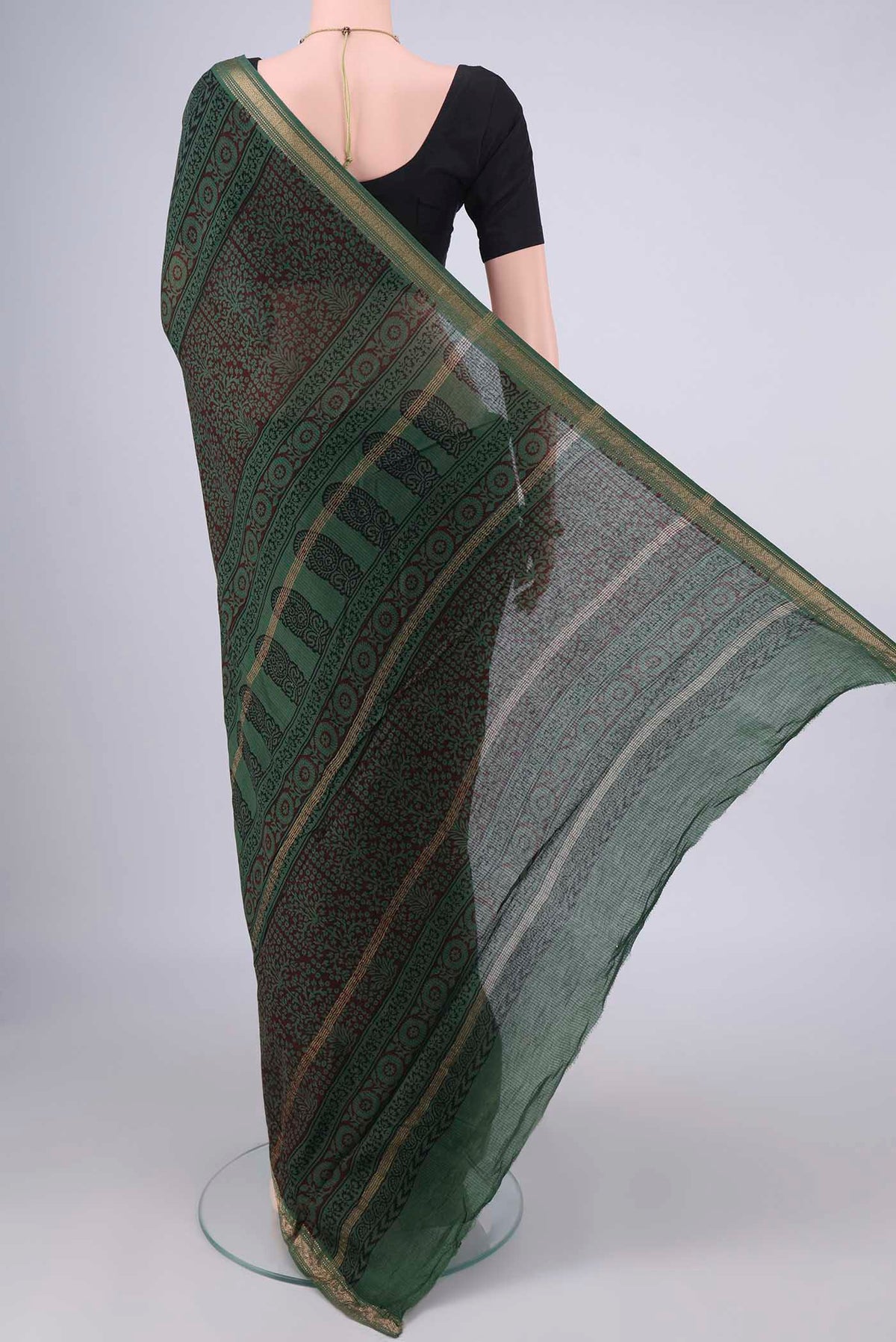 Flat view of Olive Green Maheshwari Cotton Saree with Printed design on the body and Zari Border. 