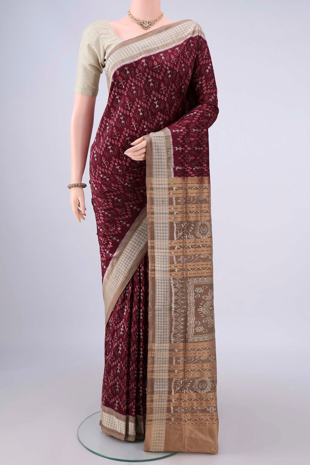 Pure Silk Maroon Orissa Saree with Pure Ikat on the body and Thread Border.  displayed on a mannequin