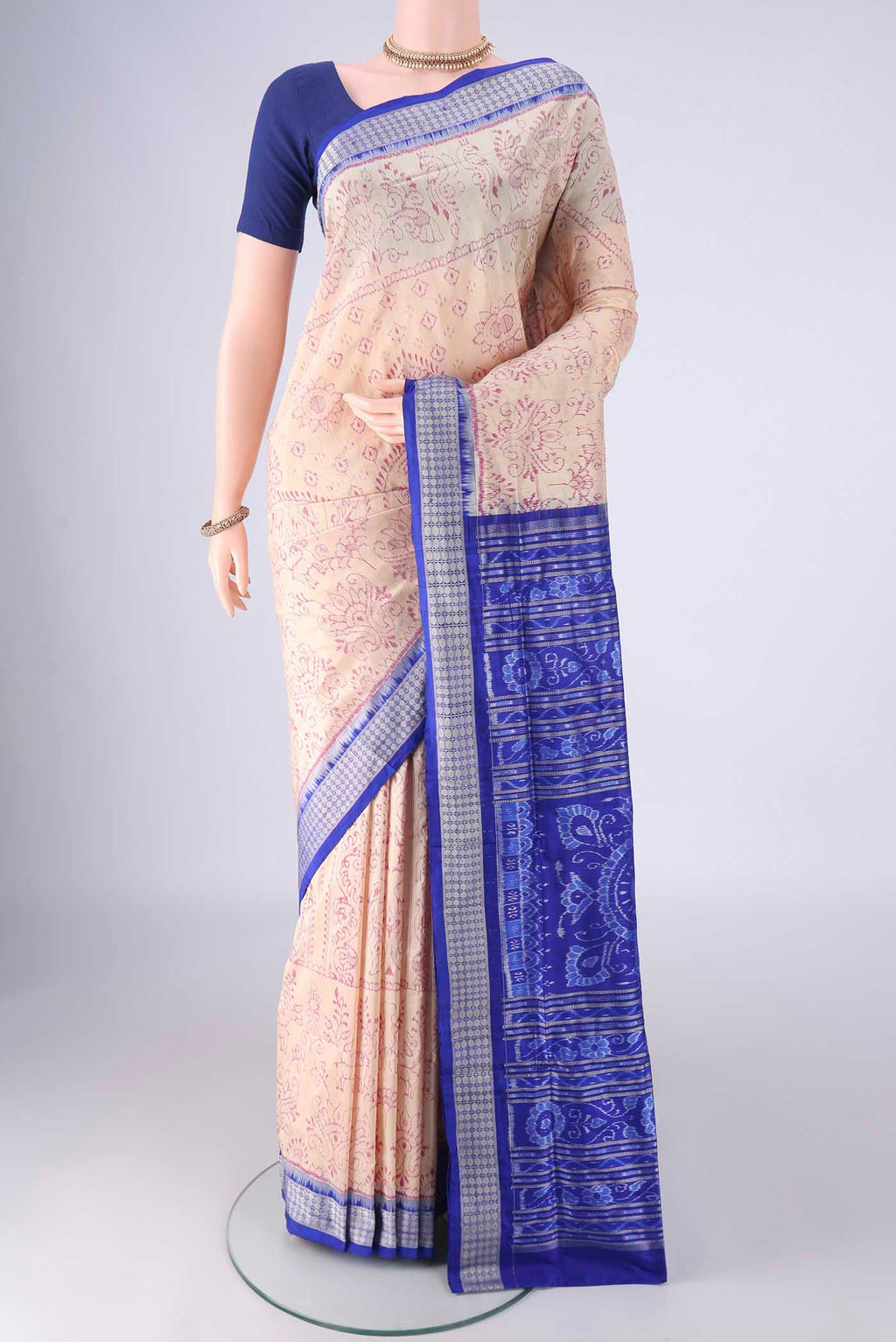 Cream Orissa Silk Saree with Ikat design on the body and Thread Border.  displayed on a mannequin