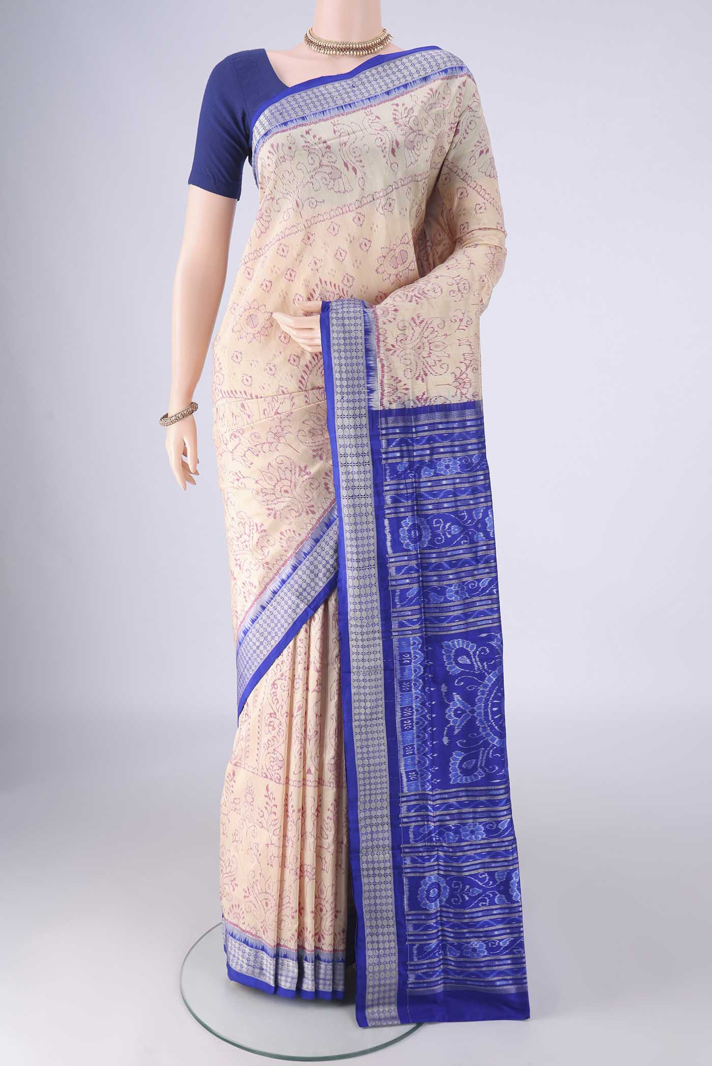 Cream Orissa Silk Saree with Ikat design on the body and Thread Border.  displayed on a mannequin