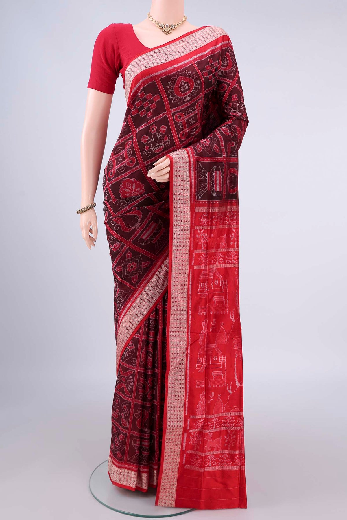 Pure Silk Brown Orissa Ikat Saree with Ikat design on the body and Thread Border.  displayed on a mannequin