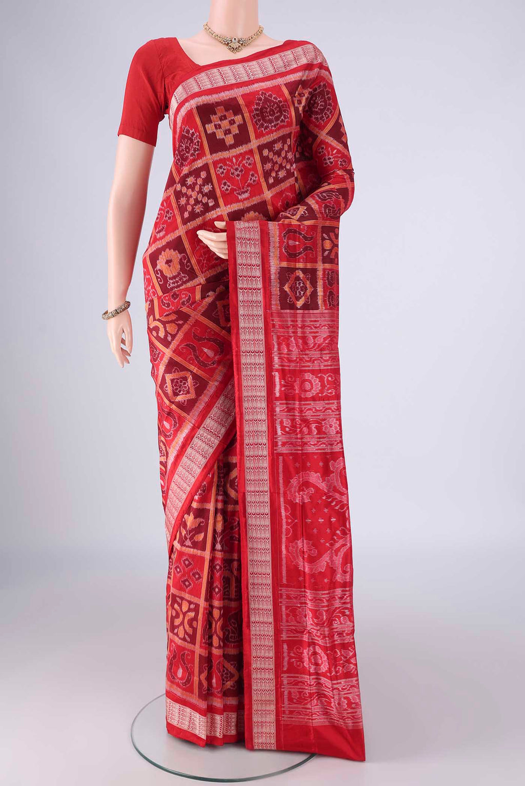 Red Orissa Silk Saree with Pure Ikat on the body and Thread Border.  displayed on a mannequin