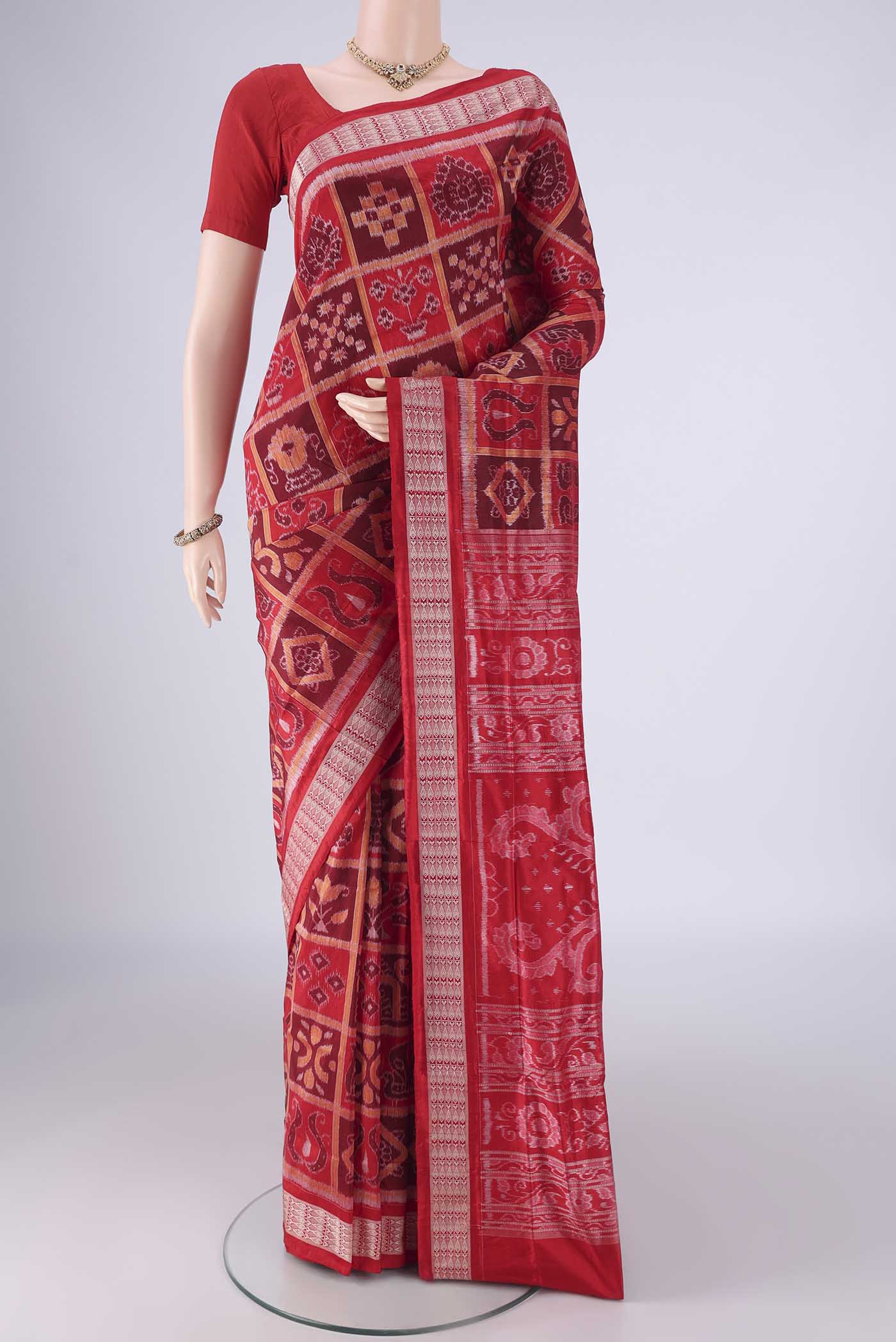 Red Orissa Silk Saree with Pure Ikat on the body and Thread Border.  displayed on a mannequin