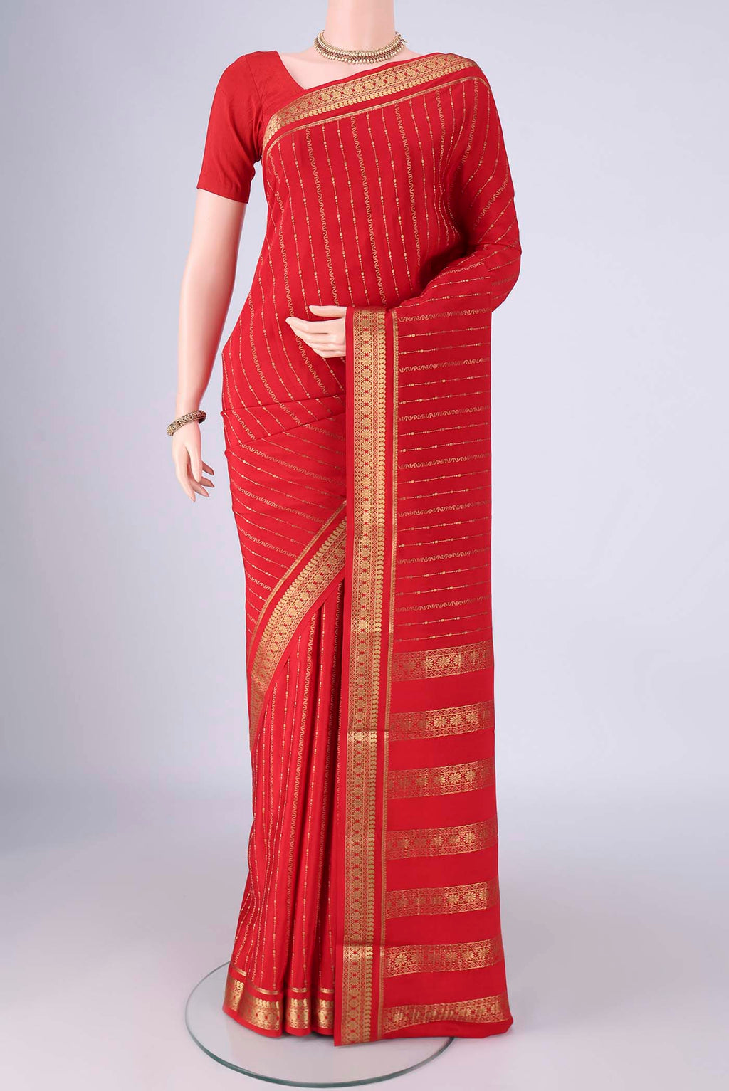 Red Mysore Crepe Saree with Stripes on the body and Zari Border.  displayed on a mannequin