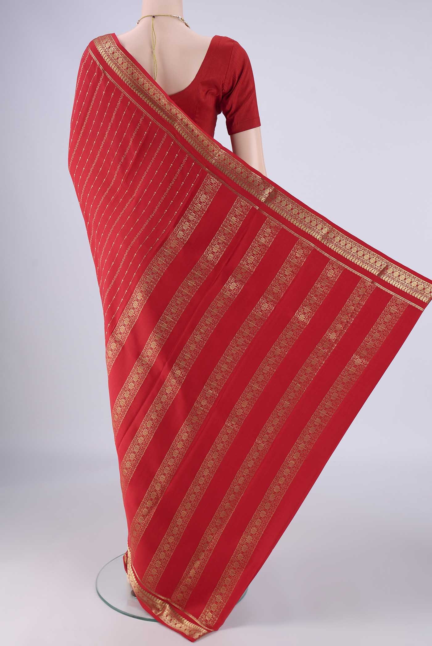 Flat view of Red Mysore Crepe Saree with Stripes on the body and Zari Border. 
