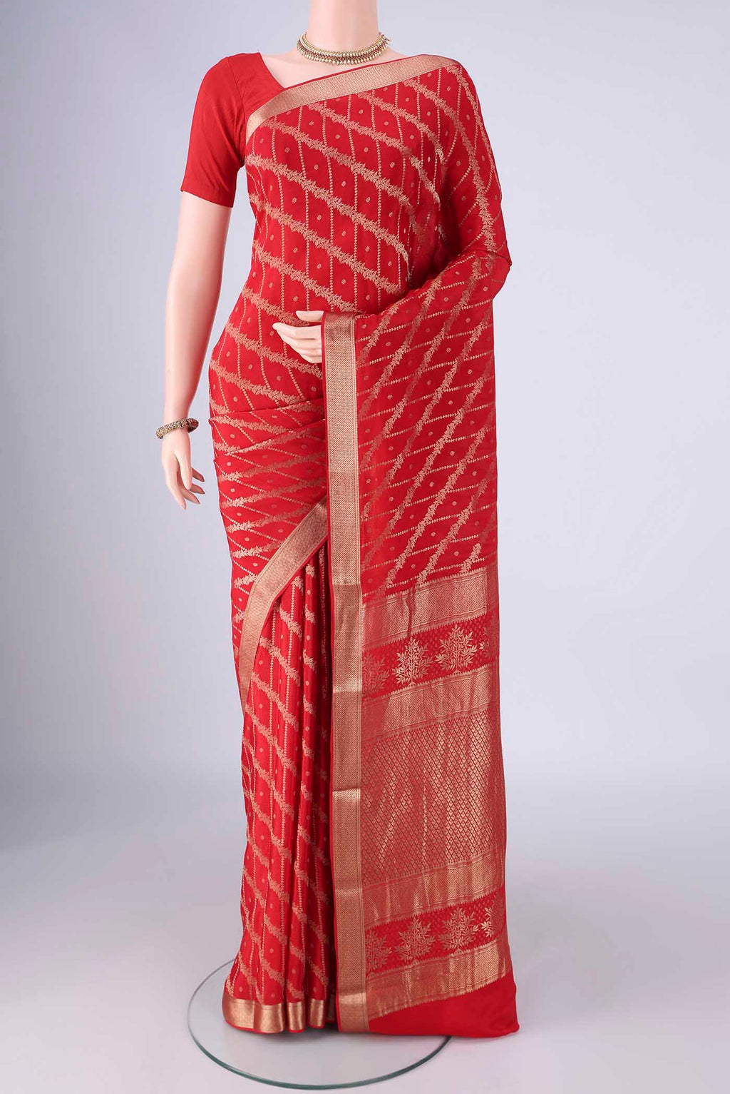 Red Mysore Crepe Saree with Zari Brocade on the body and Zari Border.  displayed on a mannequin