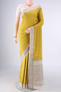 Mustard Mysore Crepe Saree with Plain Body and Zari Border.  displayed on a mannequin