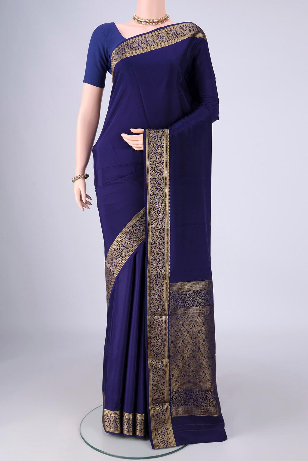 Navy Blue Mysore Crepe Saree with Plain Body and Zari Border.  displayed on a mannequin