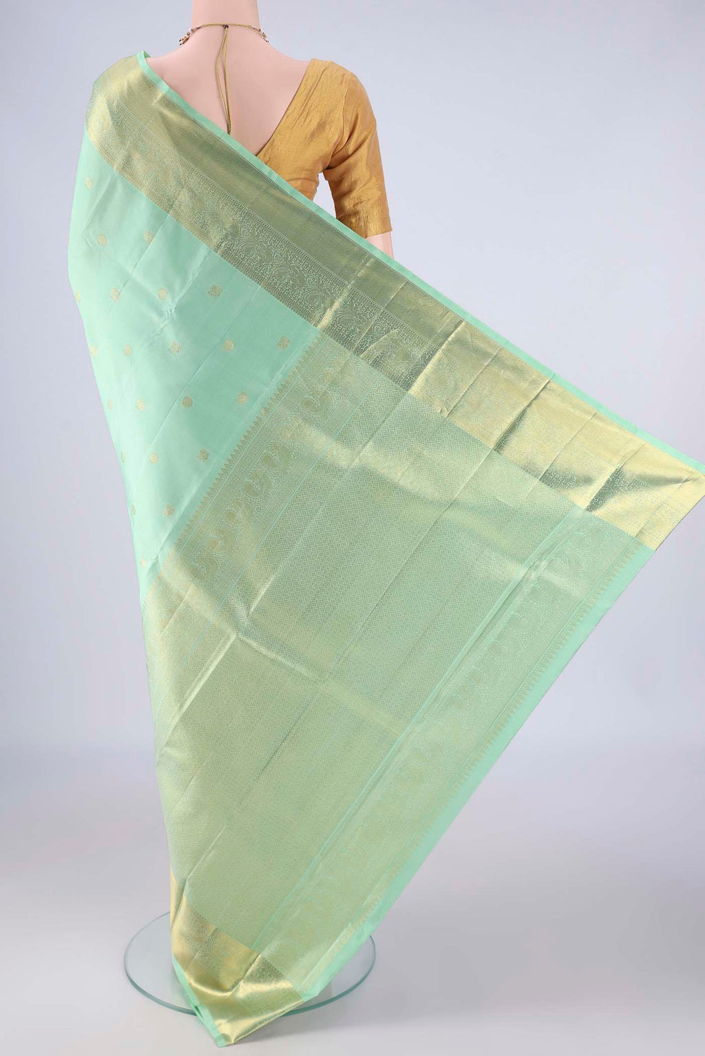 Flat view of Sea Green Kanchipuram Silk Saree with Zari Butta on the body and Zari Border. 