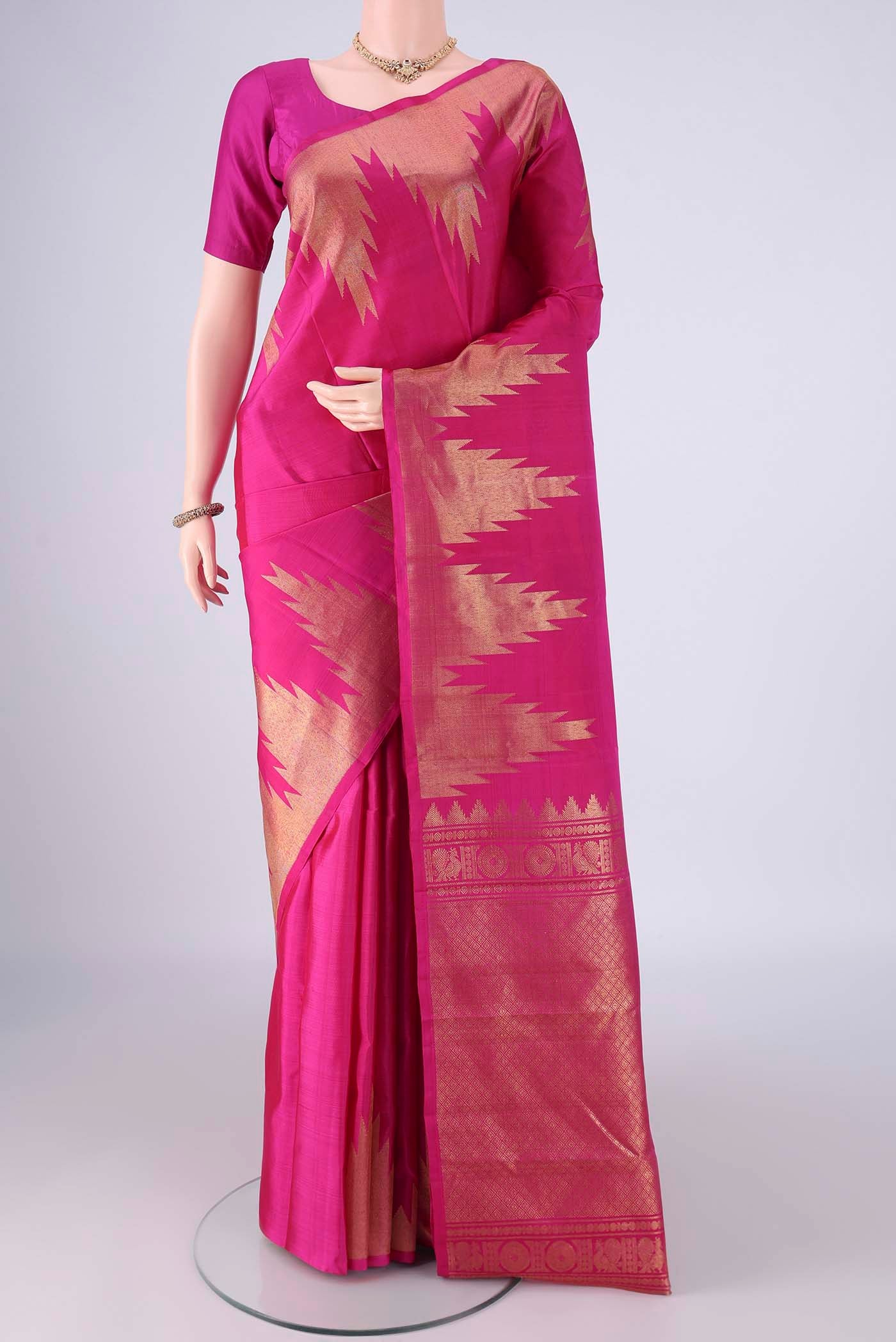 Rani Pink Kanchipuram Silk Saree with Plain Body and Temple Border.  displayed on a mannequin