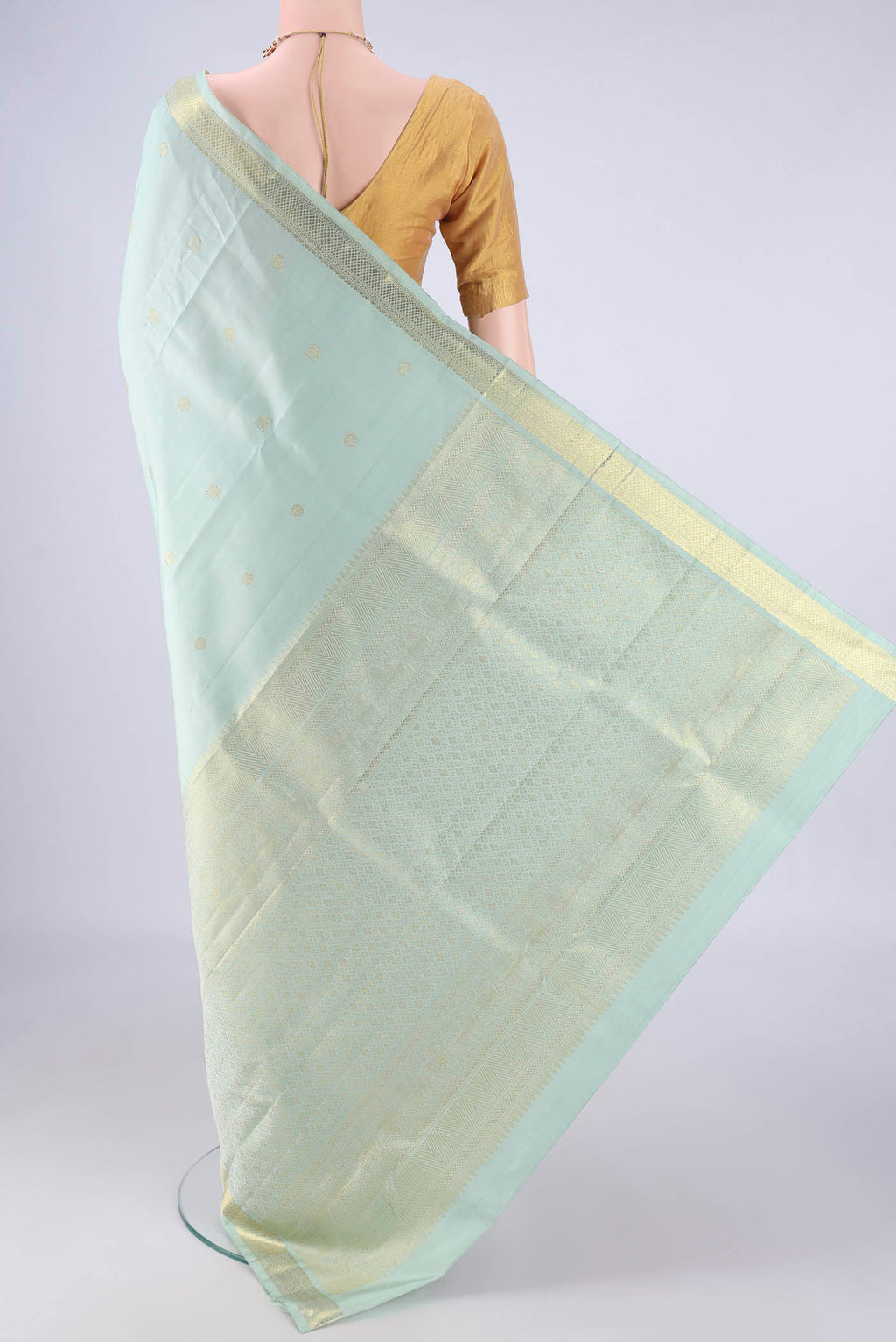 Flat view of Light Blue Kanchipuram Silk Saree with Zari Butta on the body and Zari Border. 
