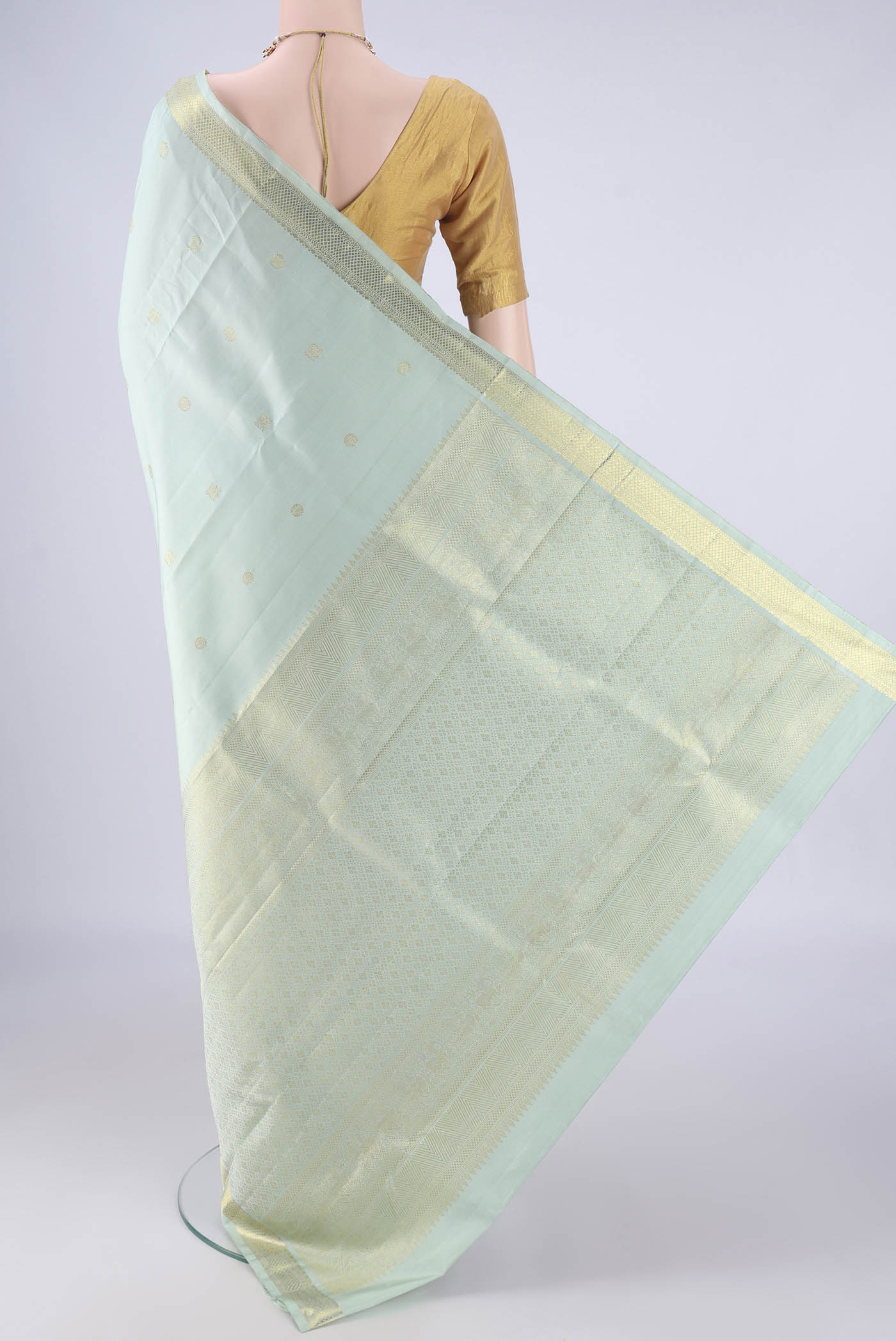 Flat view of Light Blue Kanchipuram Silk Saree with Zari Butta on the body and Zari Border. 