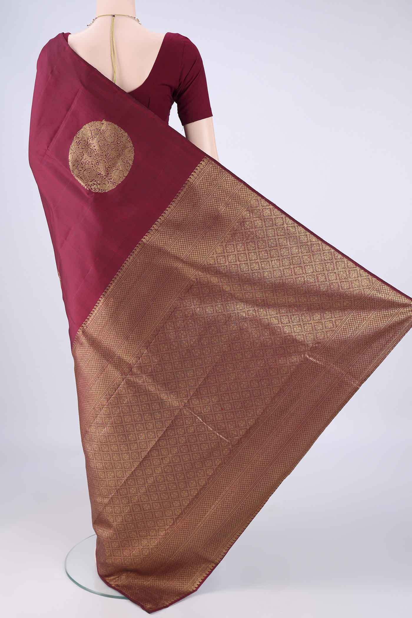 Flat view of Maroon Kanchipuram Silk Saree with Zari Butta on the body and Without Border. 