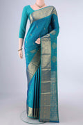 Pure Silk Peacock Blue Kanchipuram Saree with Zari Butta on the body and Zari Border.  displayed on a mannequin