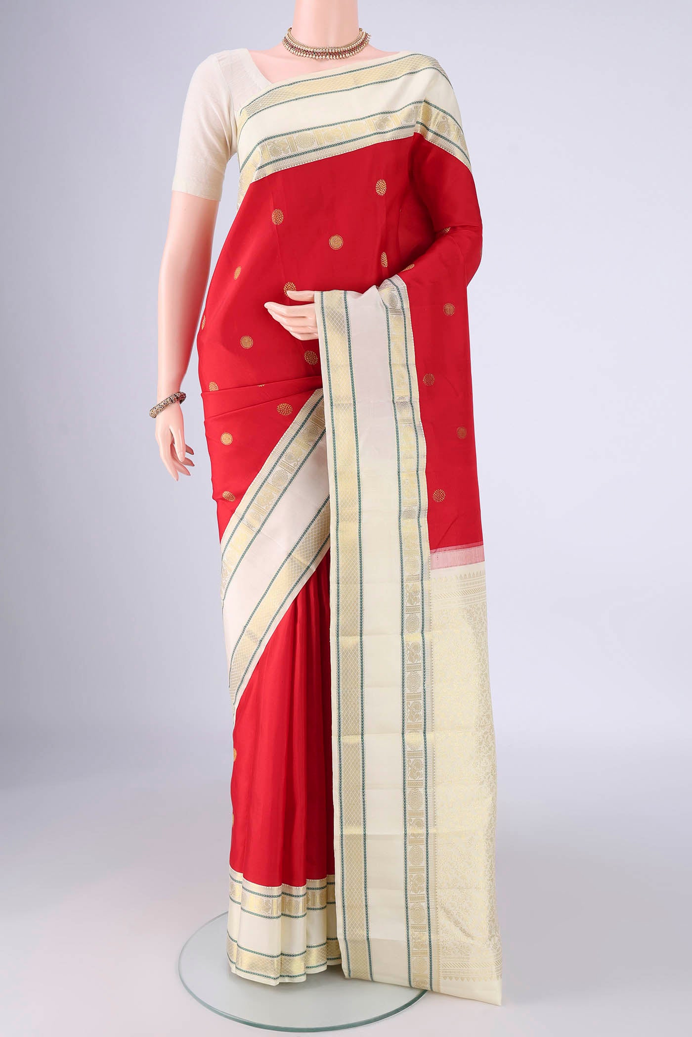 Red Kanjivaram Silk Saree with Zari Butta on the body and Zari Border.  displayed on a mannequin