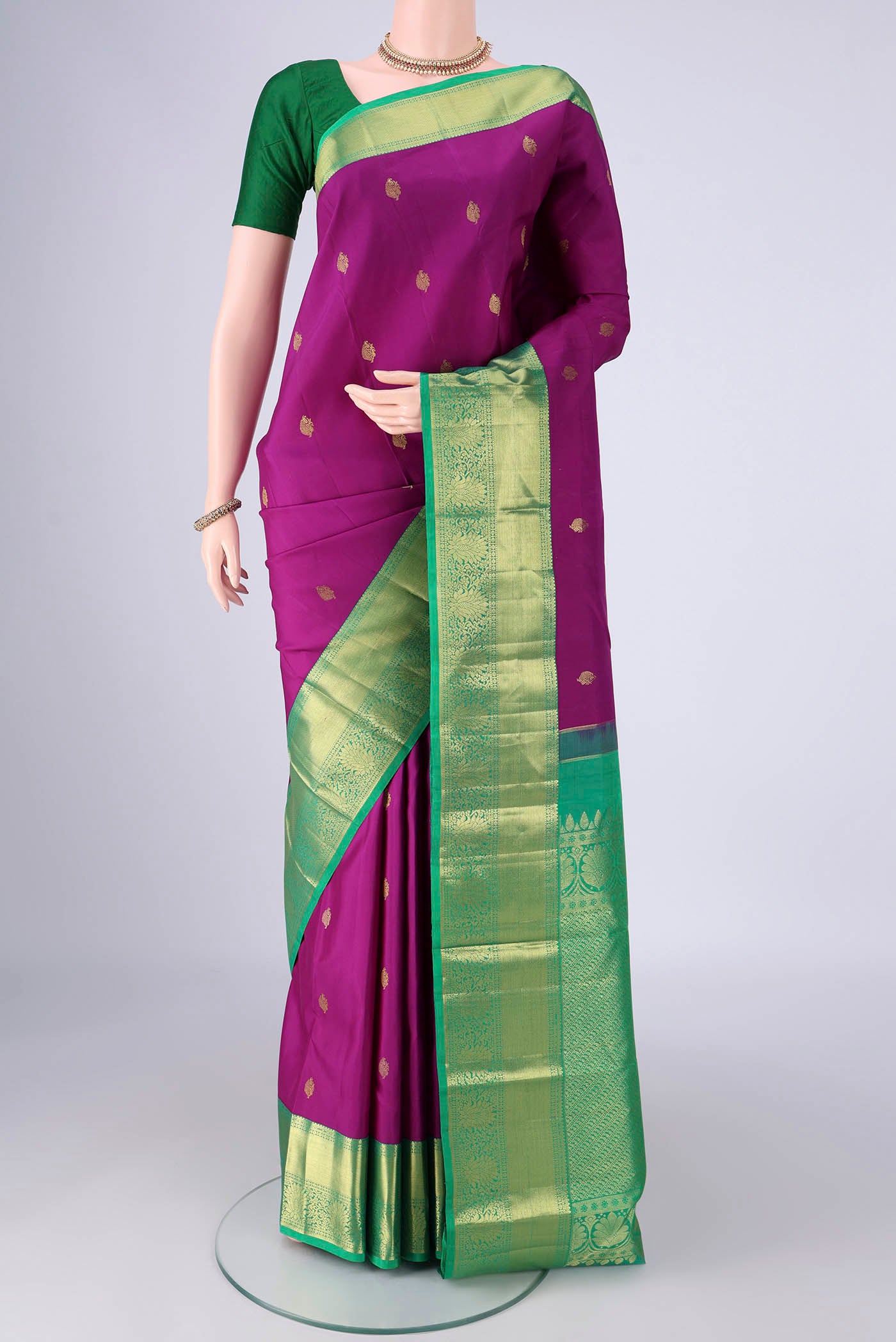 Purple Kanjivaram Silk Saree with Zari Butta on the body and Zari Border.  displayed on a mannequin