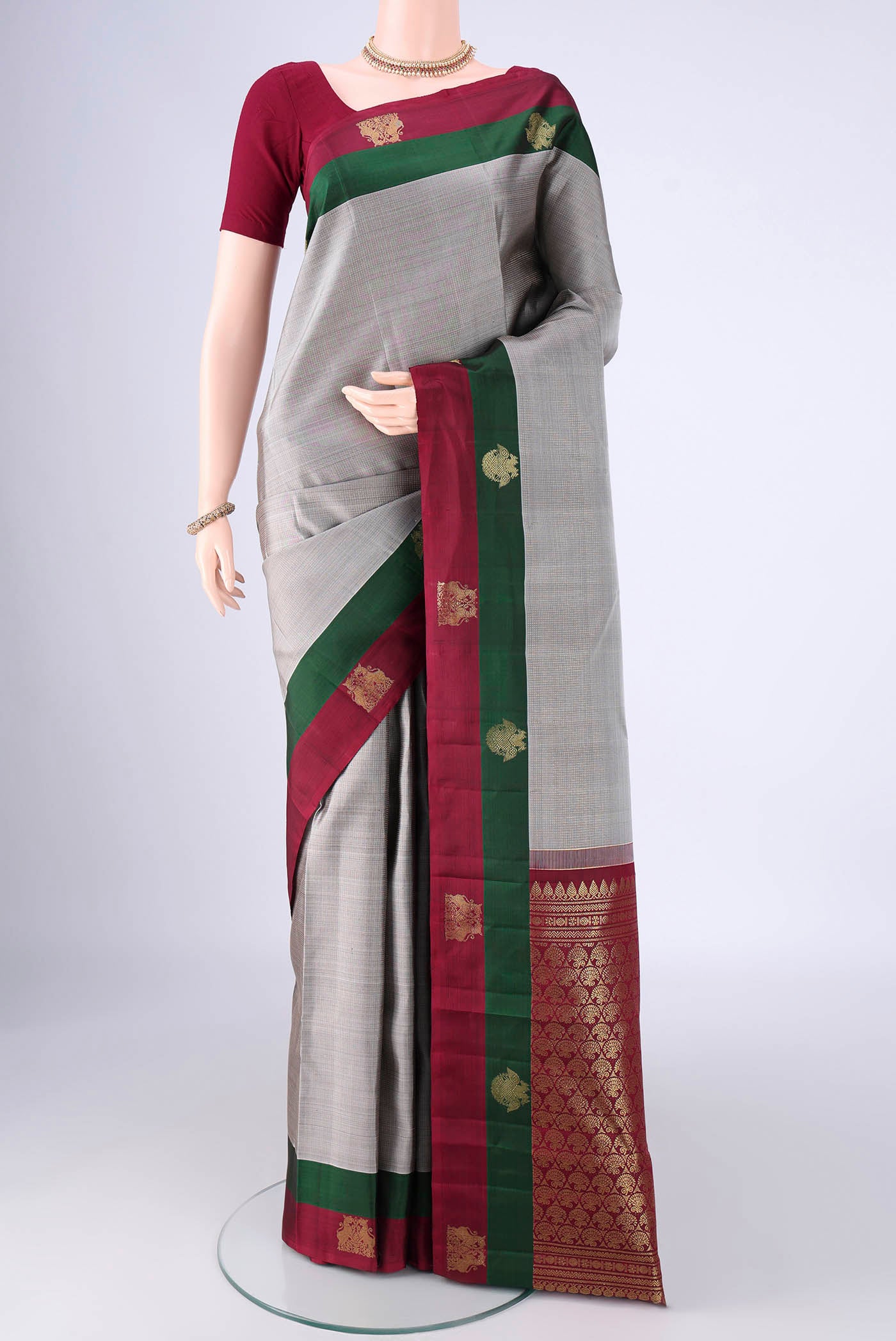 Grey Kanjivaram Silk Saree with Checked design on the body and Zari Border.  displayed on a mannequin