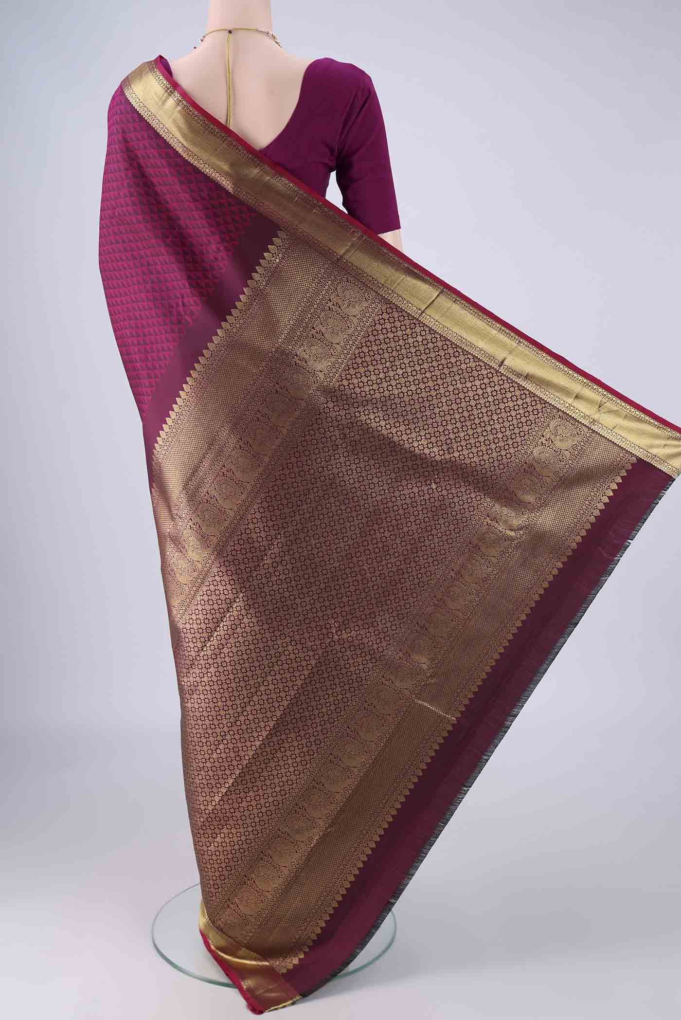 Flat view of Magenta Kanjivaram Silk Saree with Jacquard design on the body and Zari Border. 
