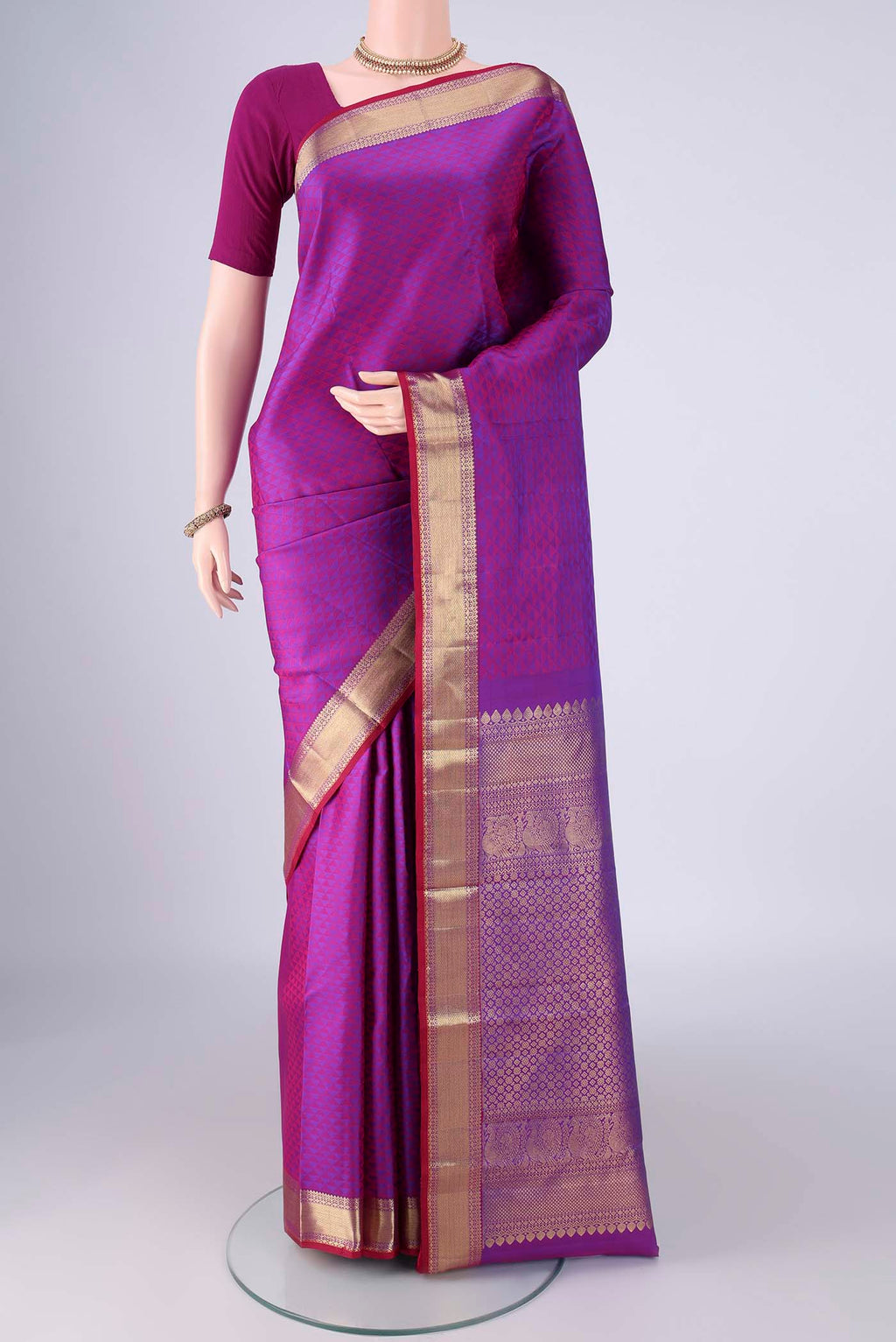 Purple Kanjivaram Silk Saree with Jacquard design on the body and Zari Border.  displayed on a mannequin