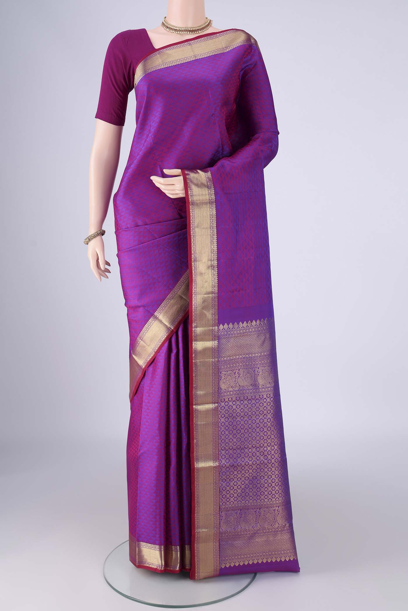 Purple Kanjivaram Silk Saree with Jacquard design on the body and Zari Border.  displayed on a mannequin