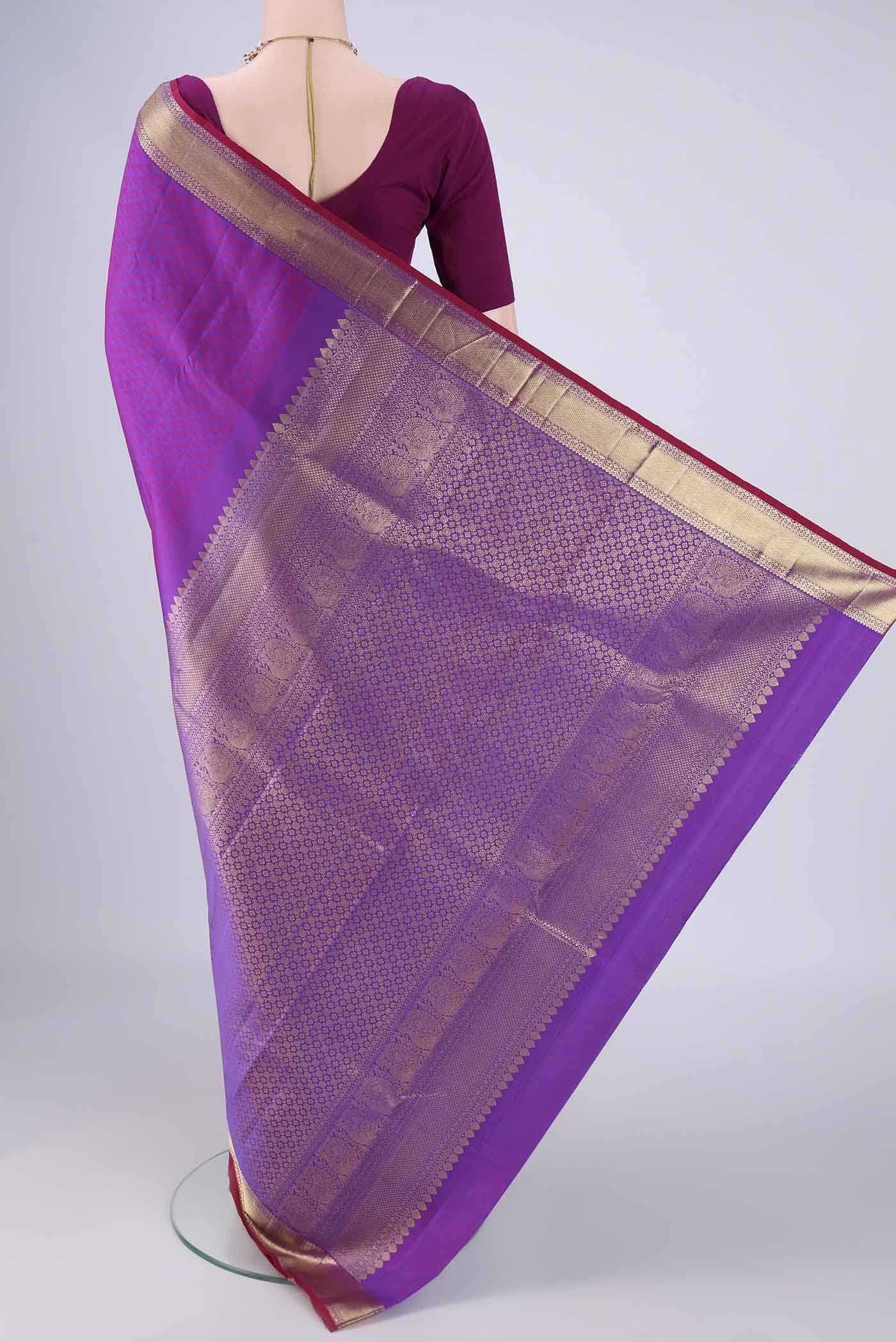 Flat view of Purple Kanjivaram Silk Saree with Jacquard design on the body and Zari Border. 
