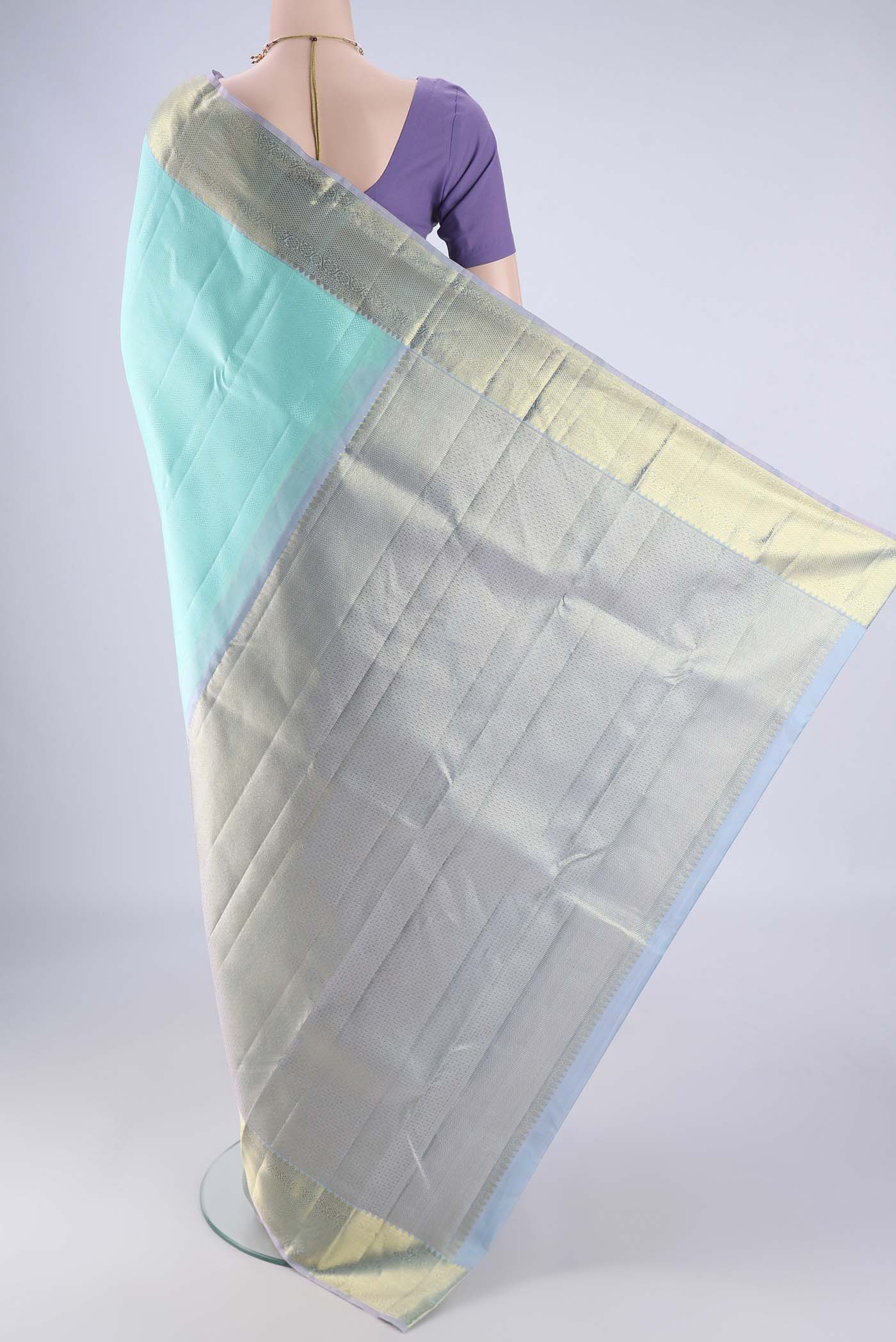 Flat view of Turquoise Kanjivaram Silk Saree with Jacquard design on the body and Zari Border. 