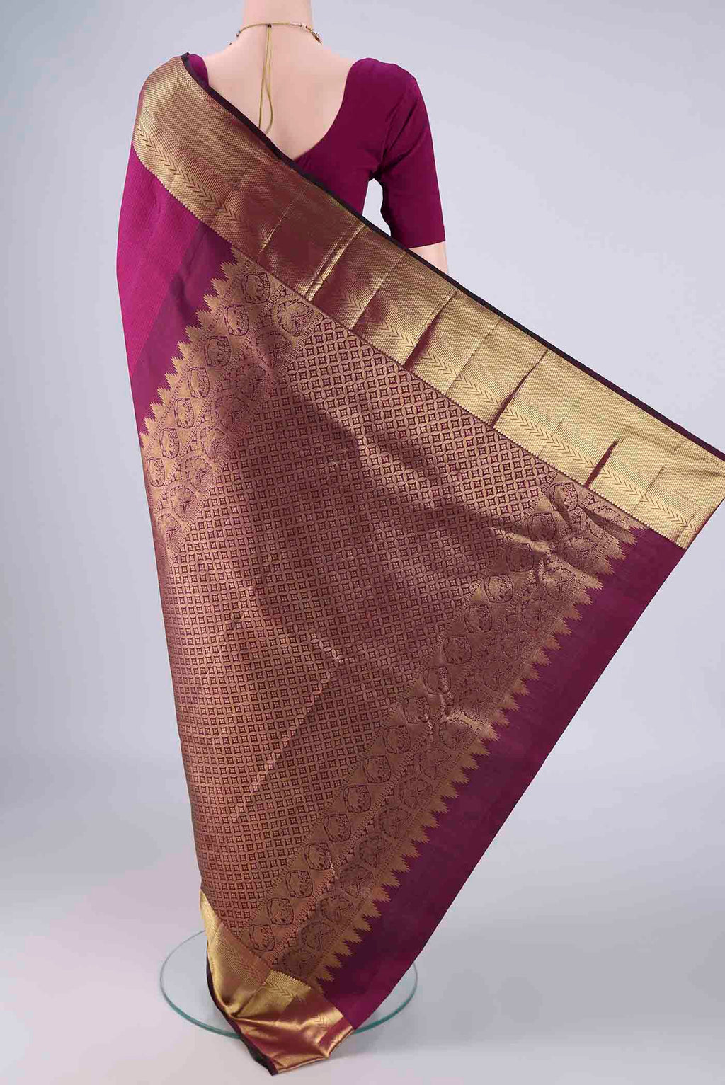 Flat view of Magenta Kanjivaram Silk Saree with Jacquard design on the body and Zari Border. 