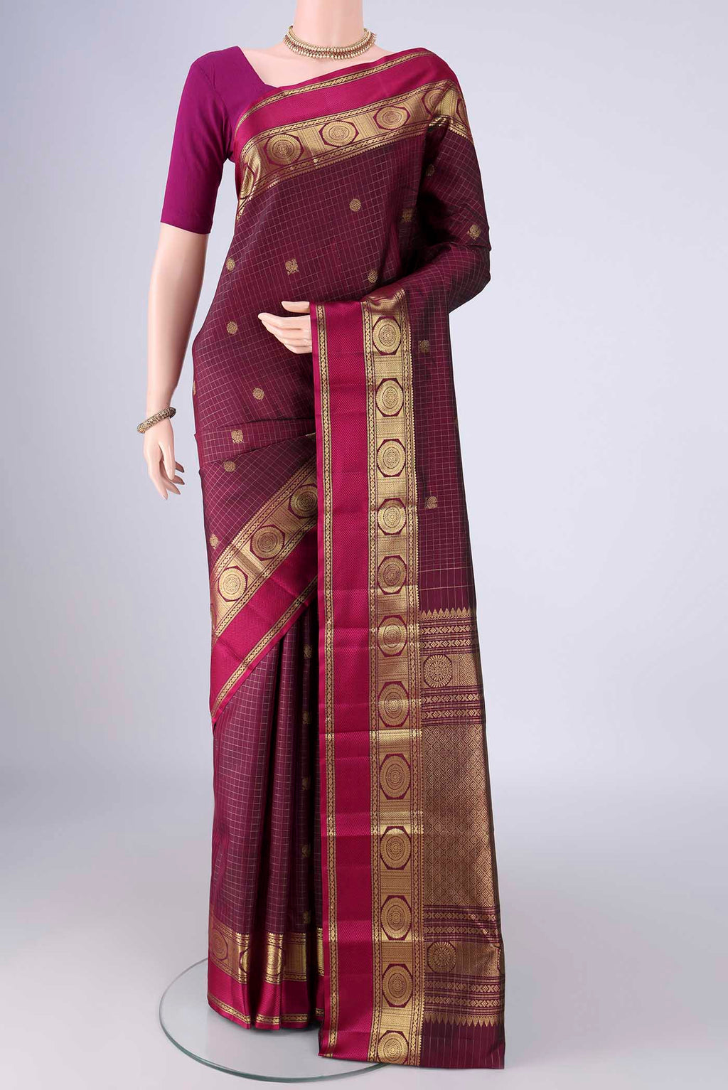Maroon Kanjivaram Silk Saree with Checked design on the body and Zari And Thread Border.  displayed on a mannequin