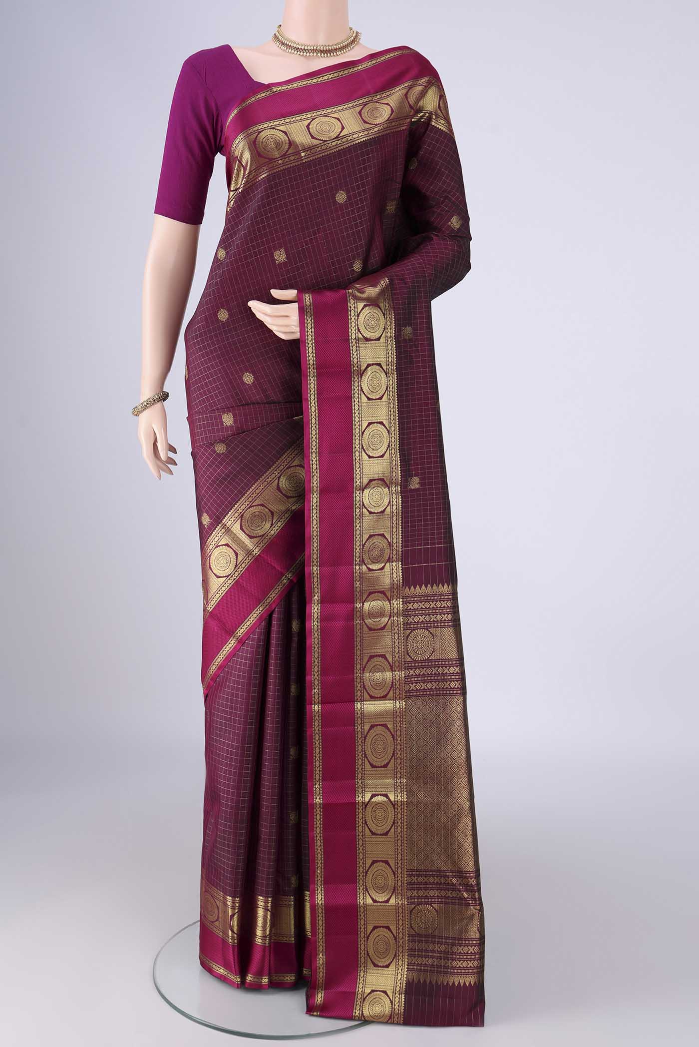 Maroon Kanjivaram Silk Saree with Checked design on the body and Zari And Thread Border.  displayed on a mannequin