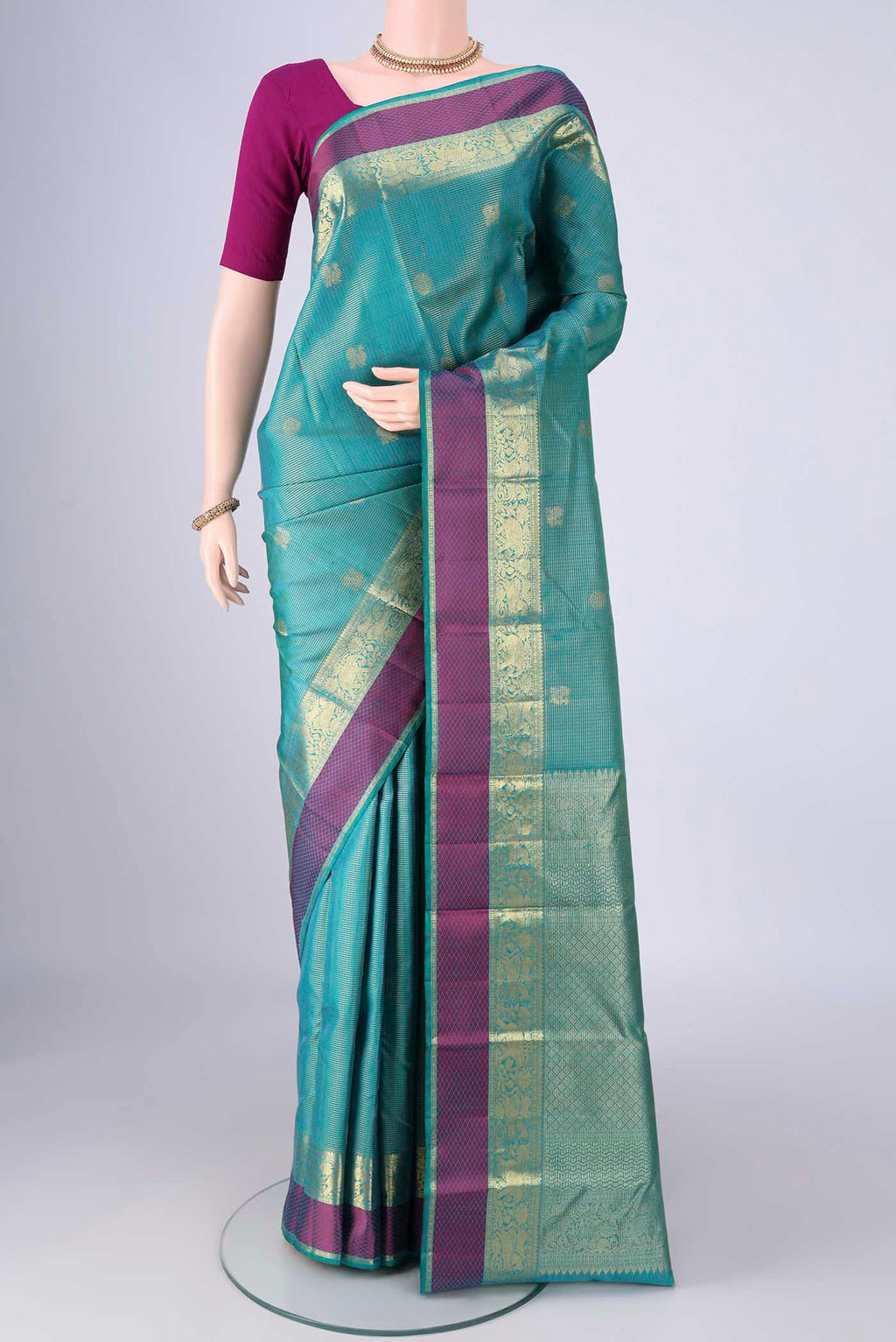 Sea Green Kanjivaram Silk Saree with Checked design on the body and Zari And Thread Border.  displayed on a mannequin
