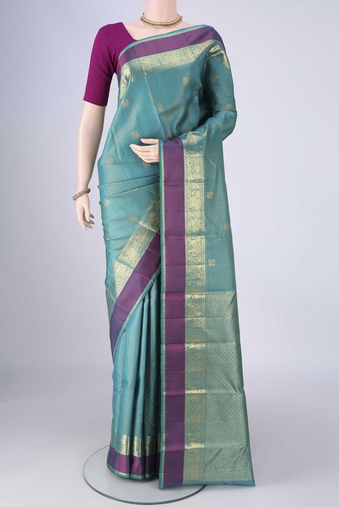 Sea Green Kanjivaram Silk Saree with Checked design on the body and Zari And Thread Border.  displayed on a mannequin