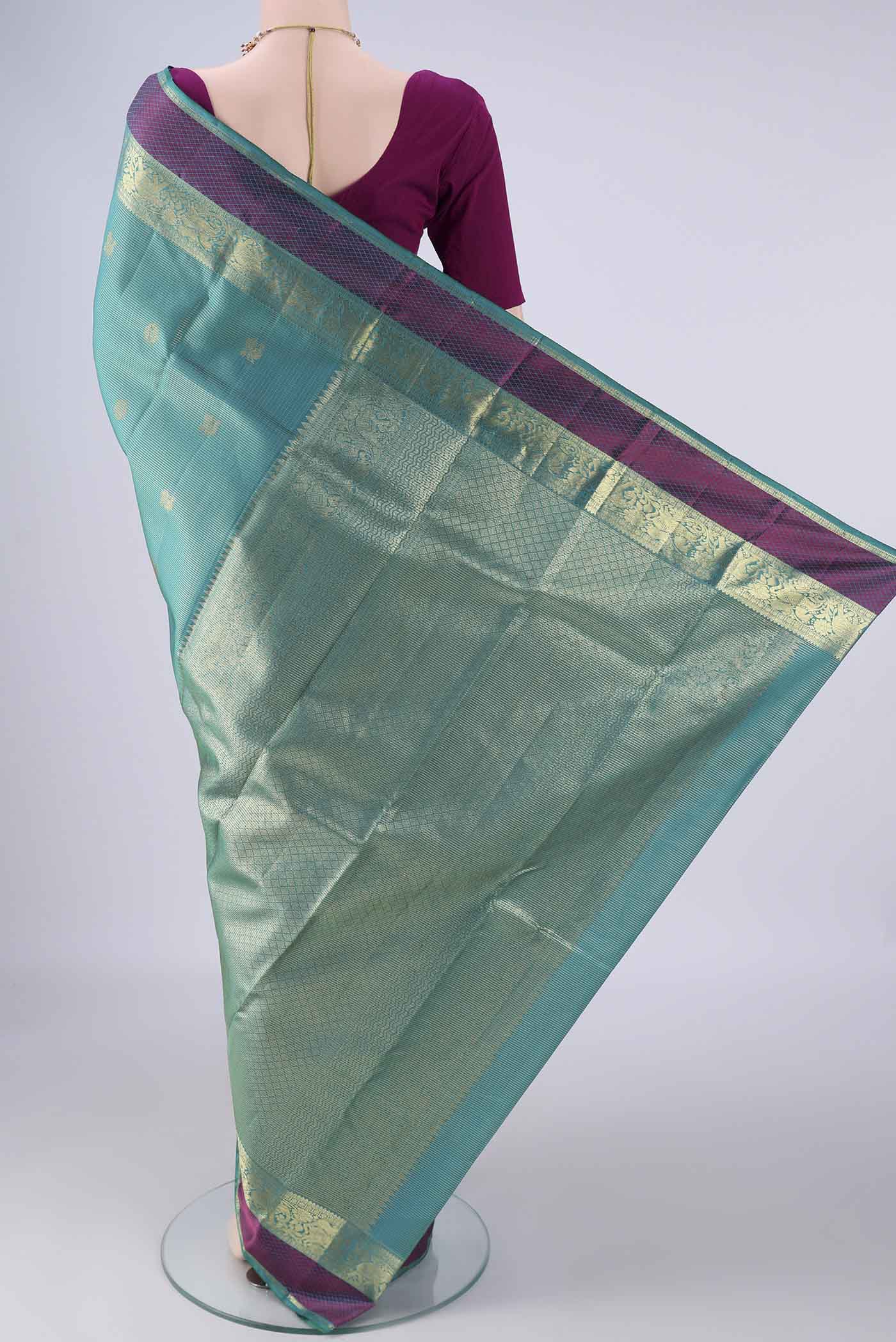 Flat view of Sea Green Kanjivaram Silk Saree with Checked design on the body and Zari And Thread Border. 