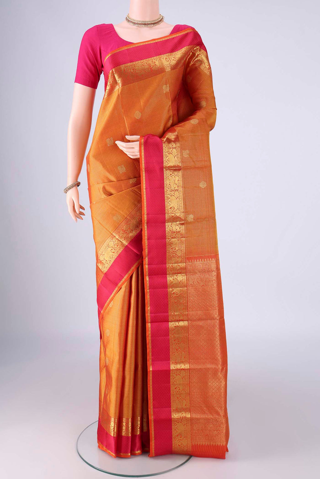Mustard Kanjivaram Silk Saree with Checked design on the body and Zari And Thread Border.  displayed on a mannequin