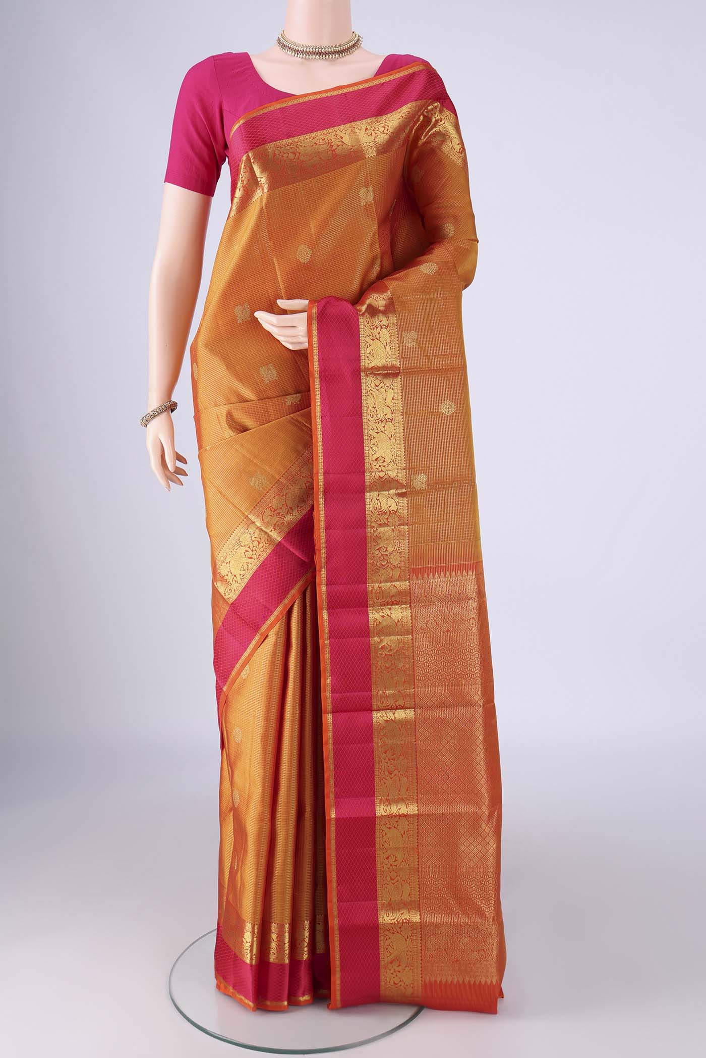 Mustard Kanjivaram Silk Saree with Checked design on the body and Zari And Thread Border.  displayed on a mannequin