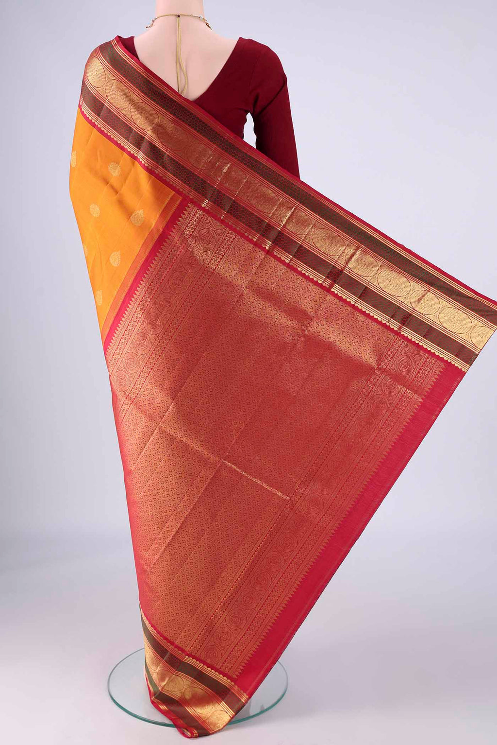 Flat view of Mustard Kanchipuram Silk Saree with Zari Butta on the body and Zari And Thread Border. 