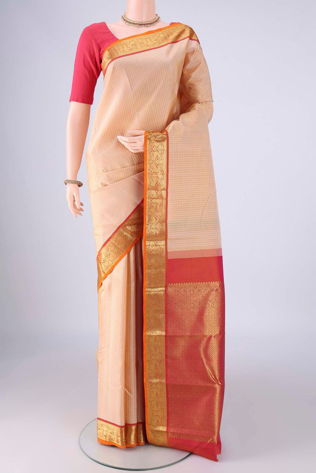 Sandal Kanchipuram Silk Saree with Checked design on the body and Zari Border.  displayed on a mannequin