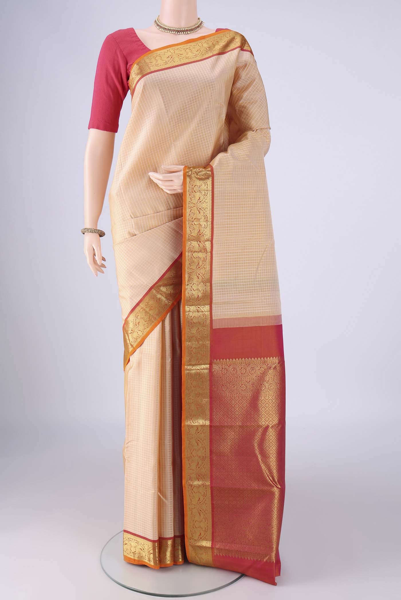 Sandal Kanchipuram Silk Saree with Checked design on the body and Zari Border.  displayed on a mannequin