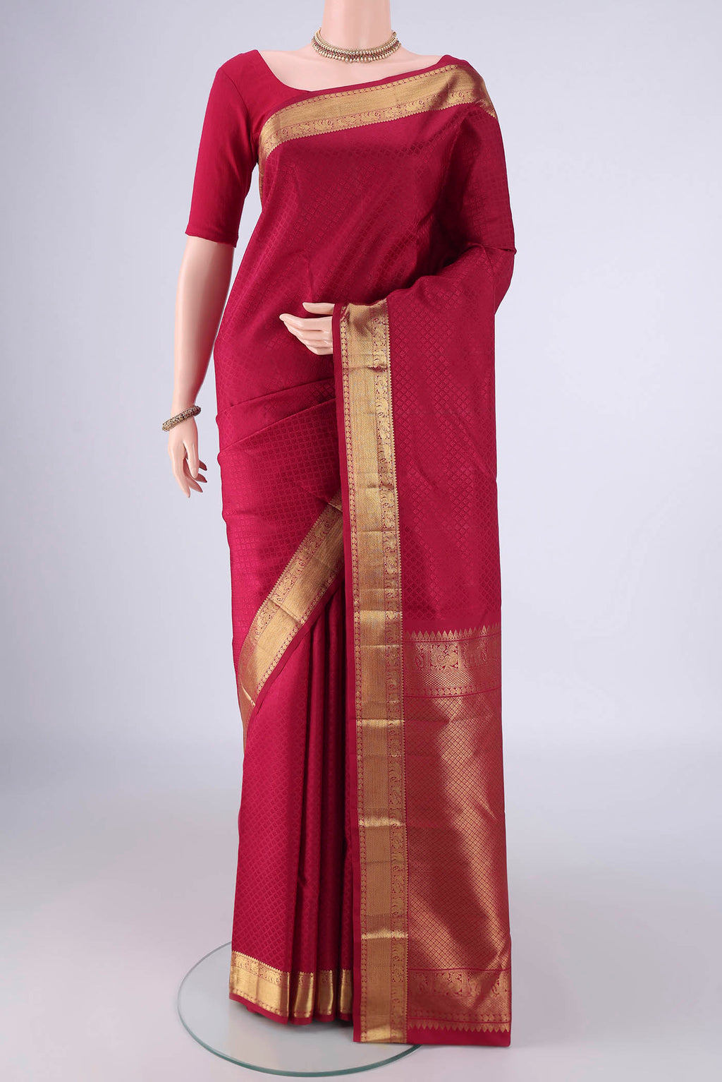 Dark Pink Kanjivaram Silk Saree with Jacquard design on the body and Zari Border.  displayed on a mannequin