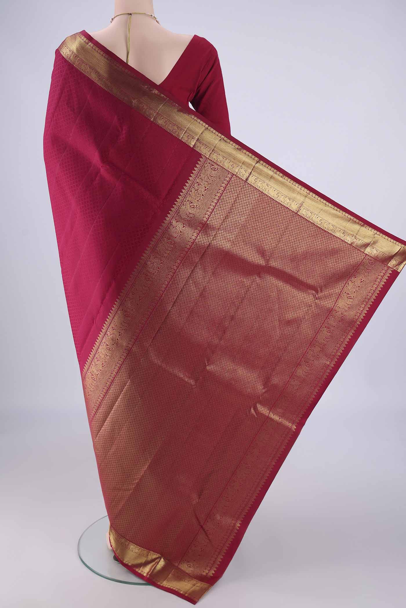 Flat view of Dark Pink Kanjivaram Silk Saree with Jacquard design on the body and Zari Border. 