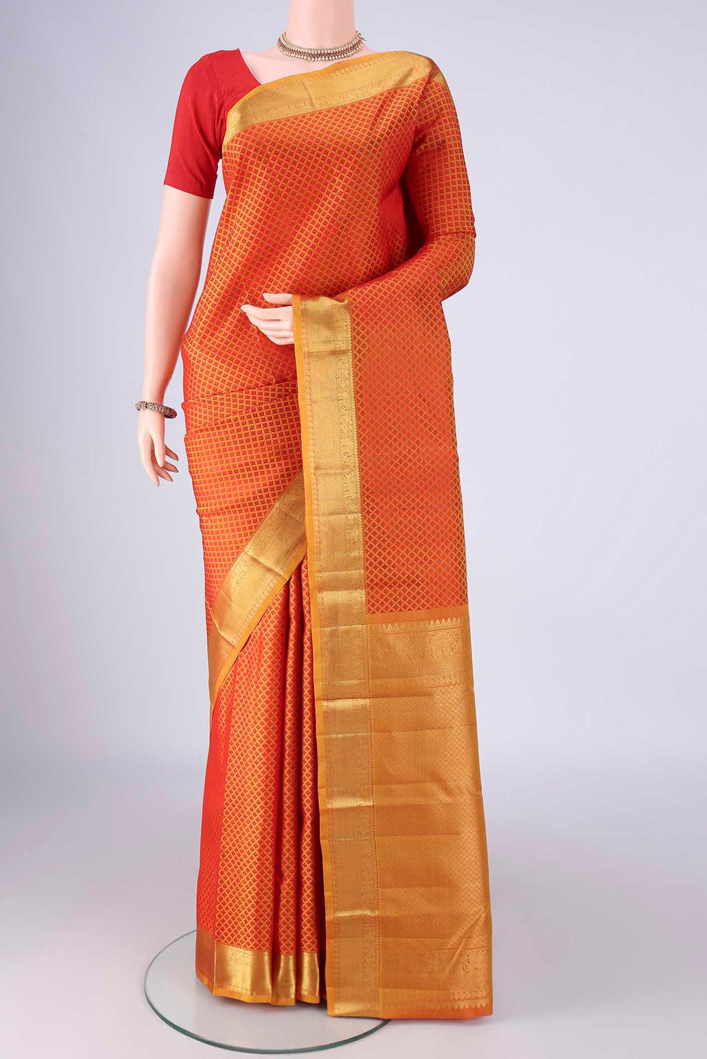 Mustard Kanjivaram Silk Saree with Jacquard design on the body and Zari Border.  displayed on a mannequin