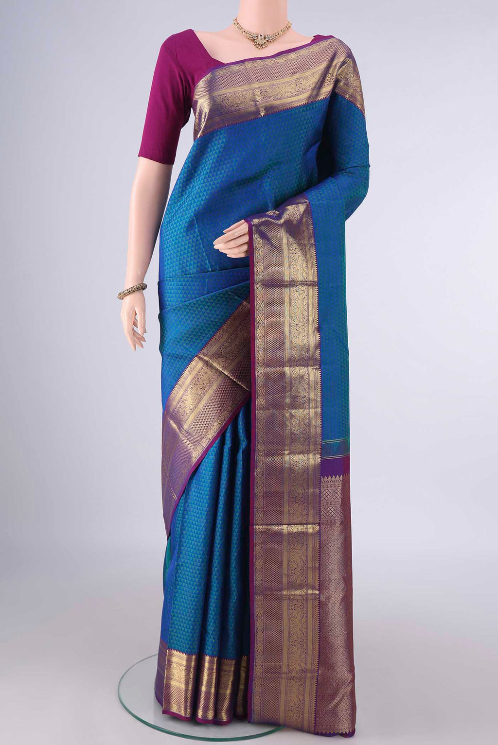 Pure Silk Peacock Blue Kanjivaram Saree with Jacquard design on the body and Zari Border.  displayed on a mannequin