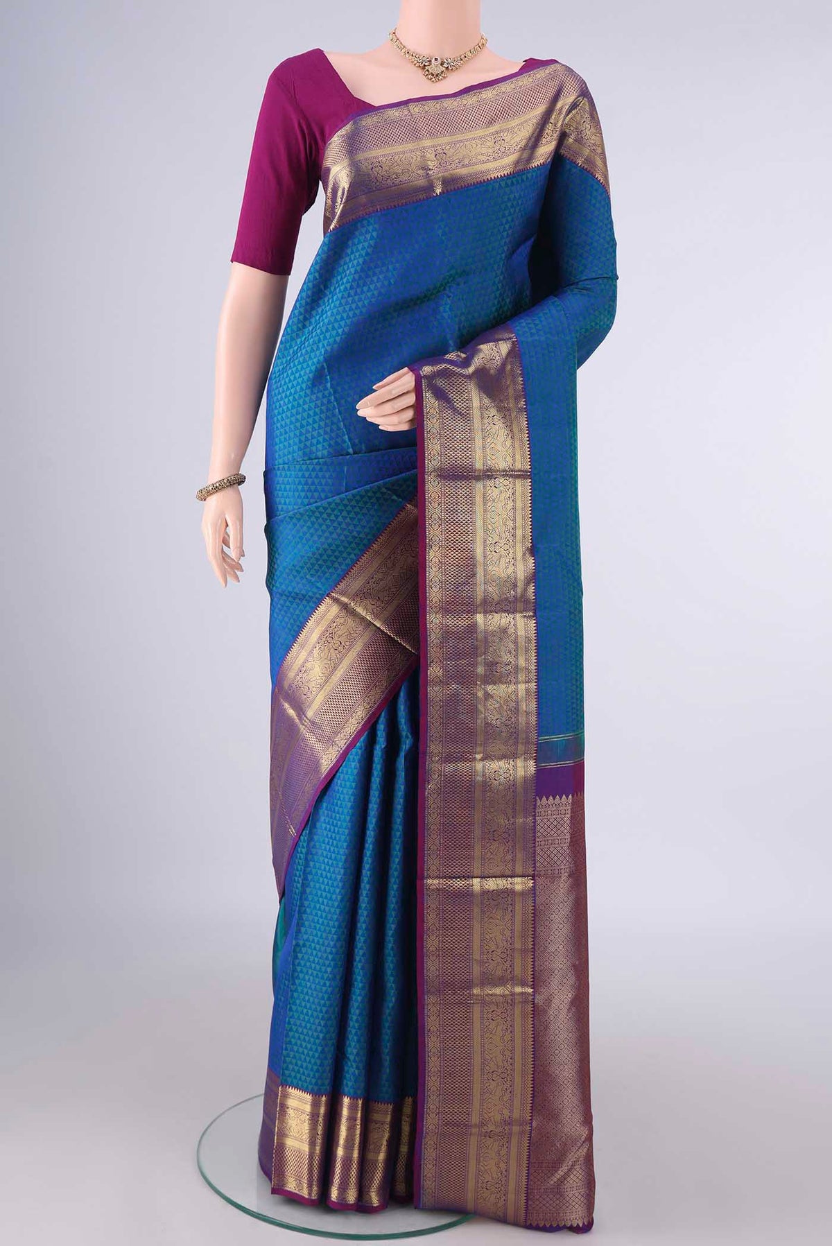 Pure Silk Peacock Blue Kanjivaram Saree with Jacquard design on the body and Zari Border.  displayed on a mannequin