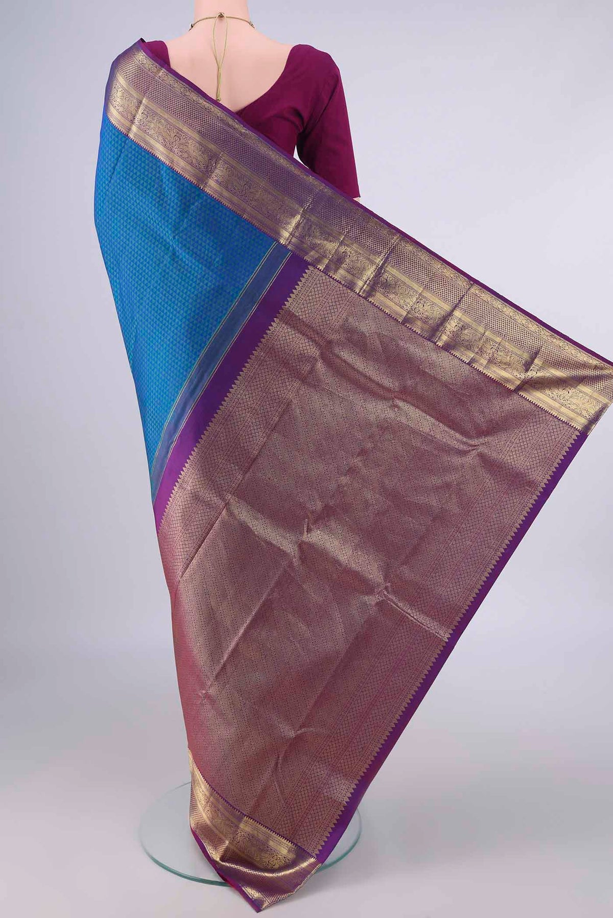 Flat view of Pure Silk Peacock Blue Kanjivaram Saree with Jacquard design on the body and Zari Border. 