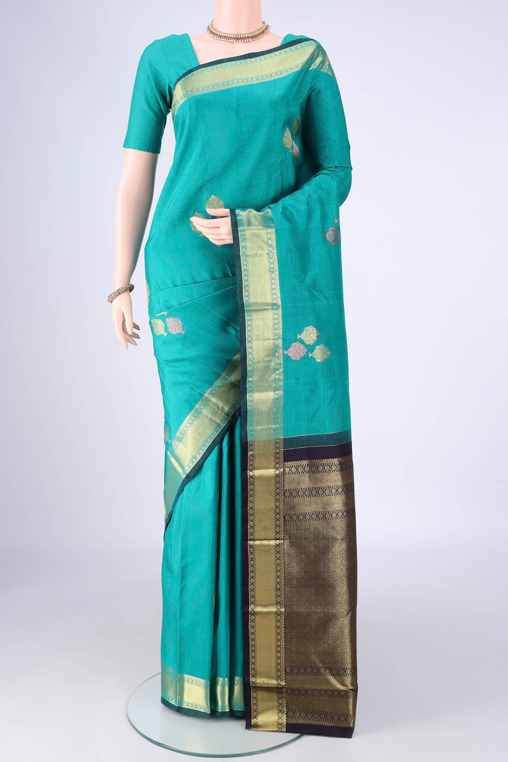 Sea Green Kanchipuram Silk Saree with Zari Butta on the body and Zari Border.  displayed on a mannequin