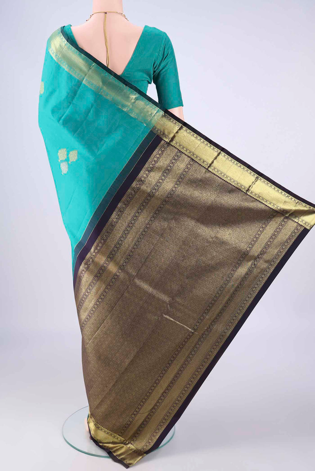 Flat view of Sea Green Kanchipuram Silk Saree with Zari Butta on the body and Zari Border. 