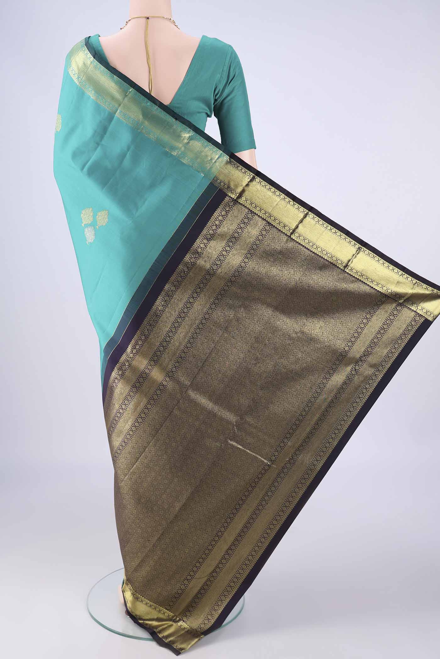 Flat view of Sea Green Kanchipuram Silk Saree with Zari Butta on the body and Zari Border. 