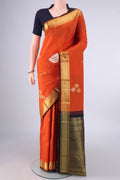 Pure Silk Orange Kanchipuram Saree with Zari Butta on the body and Zari Border.  displayed on a mannequin