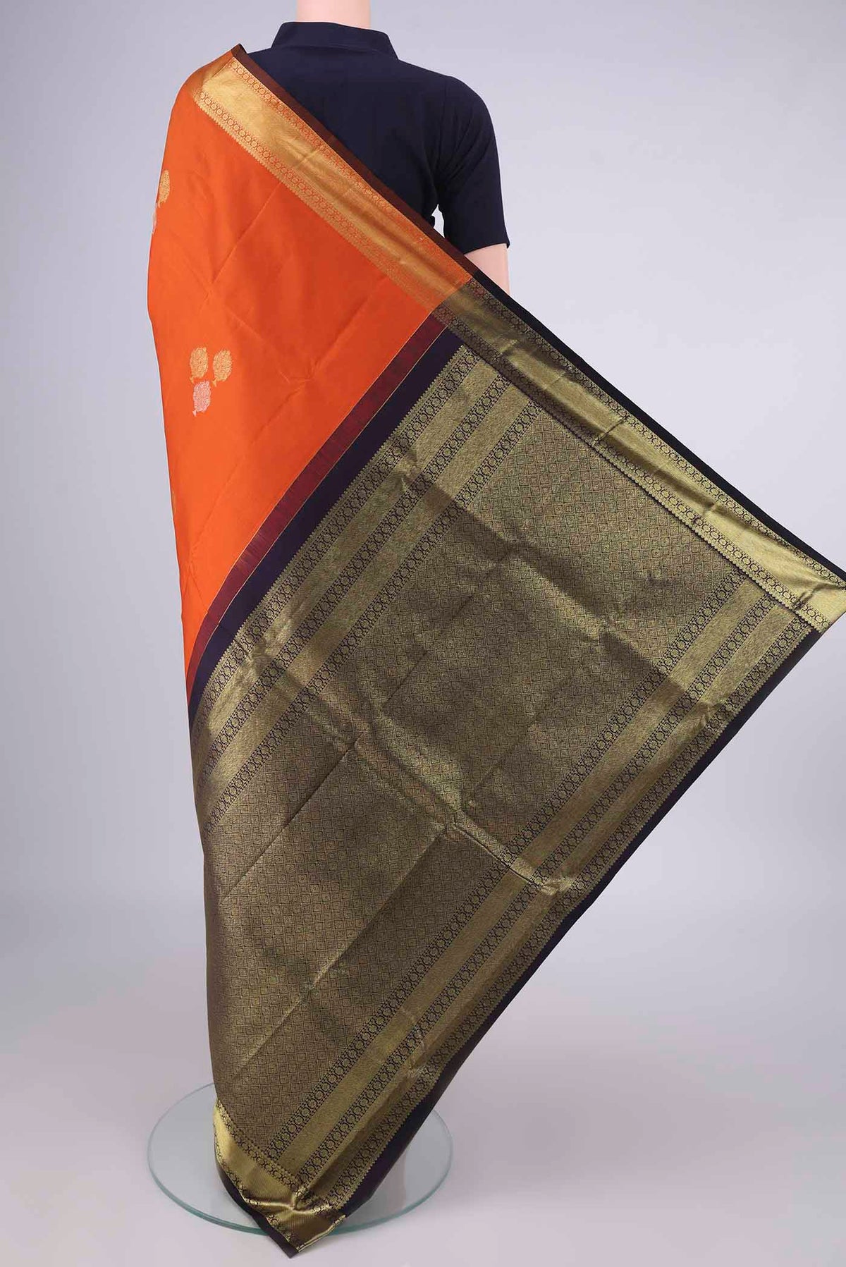 Flat view of Pure Silk Orange Kanchipuram Saree with Zari Butta on the body and Zari Border. 